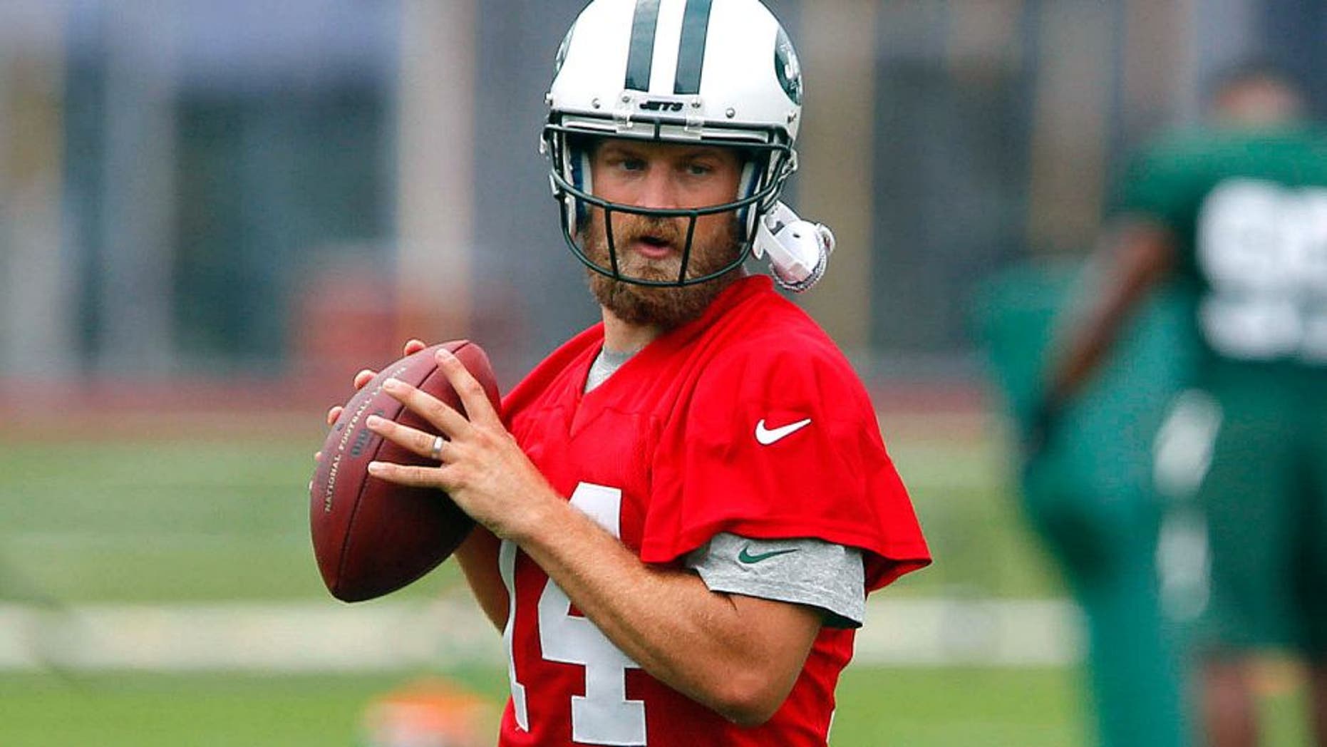 Jul 30, 2015; Florham Park, NJ, USA; New York Jets quarterback Ryan Fitzpatrick (14) and quarterback Geno Smith (7) during first day of training camp at Atlantic Health Jets Training Center. Mandatory Credit: Noah K. Murray-USA TODAY Sports