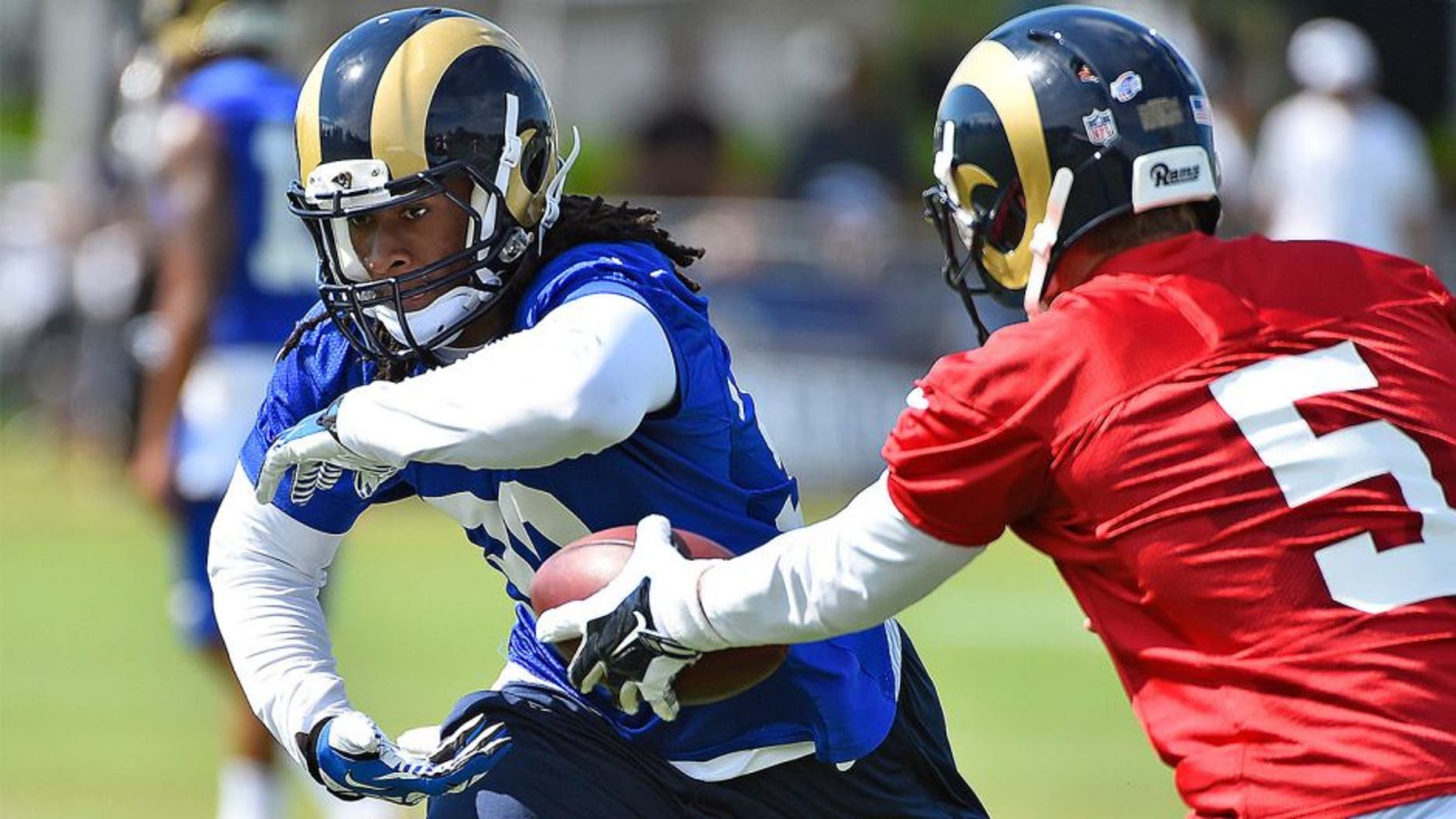 Aug 1, 2015; Earth City, MO, USA; St. Louis Rams quarterback Nick Foles (5) hands the ball to running back Todd Gurley (30) at Rams Park. Mandatory Credit: Jasen Vinlove-USA TODAY Sports