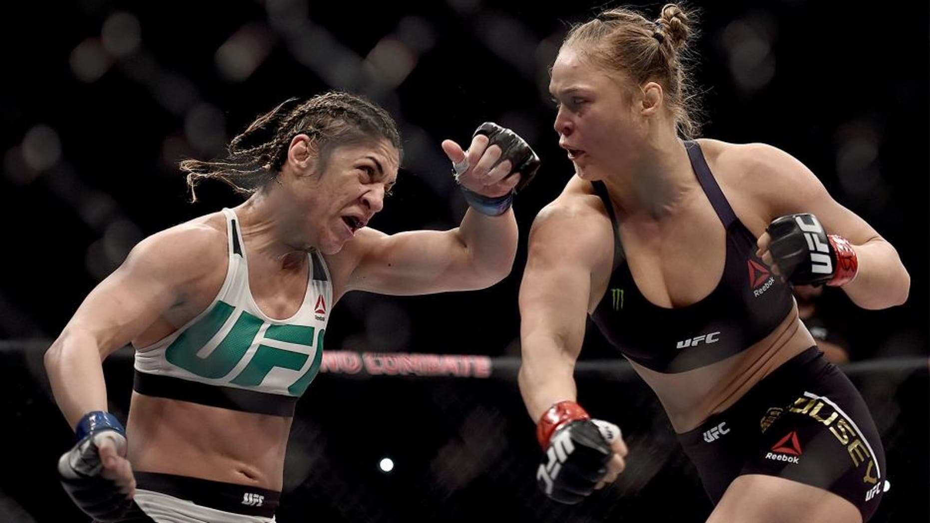 RIO DE JANEIRO, BRAZIL - AUGUST 01: Ronda Rousey of the United States punches Bethe Correia of Brazil in their bantamweight title fight during the UFC 190 Rousey v Correia at HSBC Arena on August 1, 2015 in Rio de Janeiro, Brazil. (Photo by Buda Mendes/Zuffa LLC/Zuffa LLC via Getty Images)