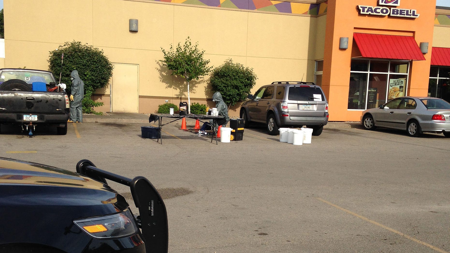 Tuesday, Aug. 4, 2015: Emergency responders examine hazardous materials in the parking lot of a Cedar Rapids Taco Bell where the remnants of a meth lab were found.