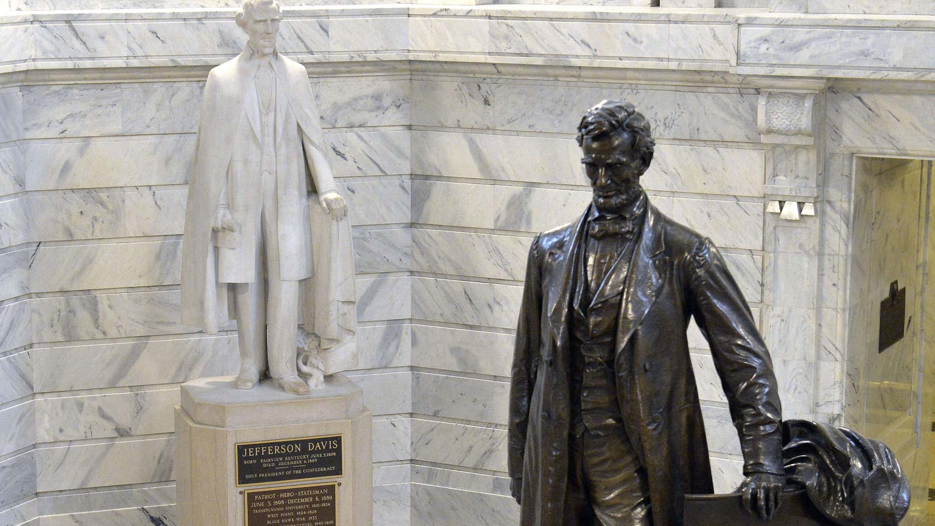 Aug. 5, 2015: The statue of Jefferson Davis, left, overlooks the statue of Abraham Lincoln in the Rotunda of the Kentucky State Capitol in Frankfort Ky.
