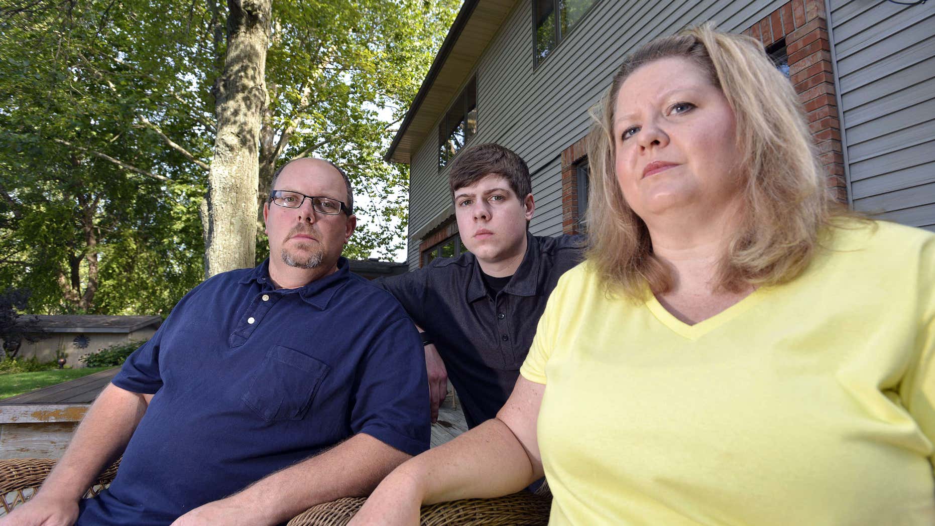 July 22, 2015: Zach Anderson, center, and his parents, Les and Amanda Anderson, pose for a photo at their home in Elkhart, Ind. Zach and his parents are embroiled in a legal battle with a Niles, Mich.