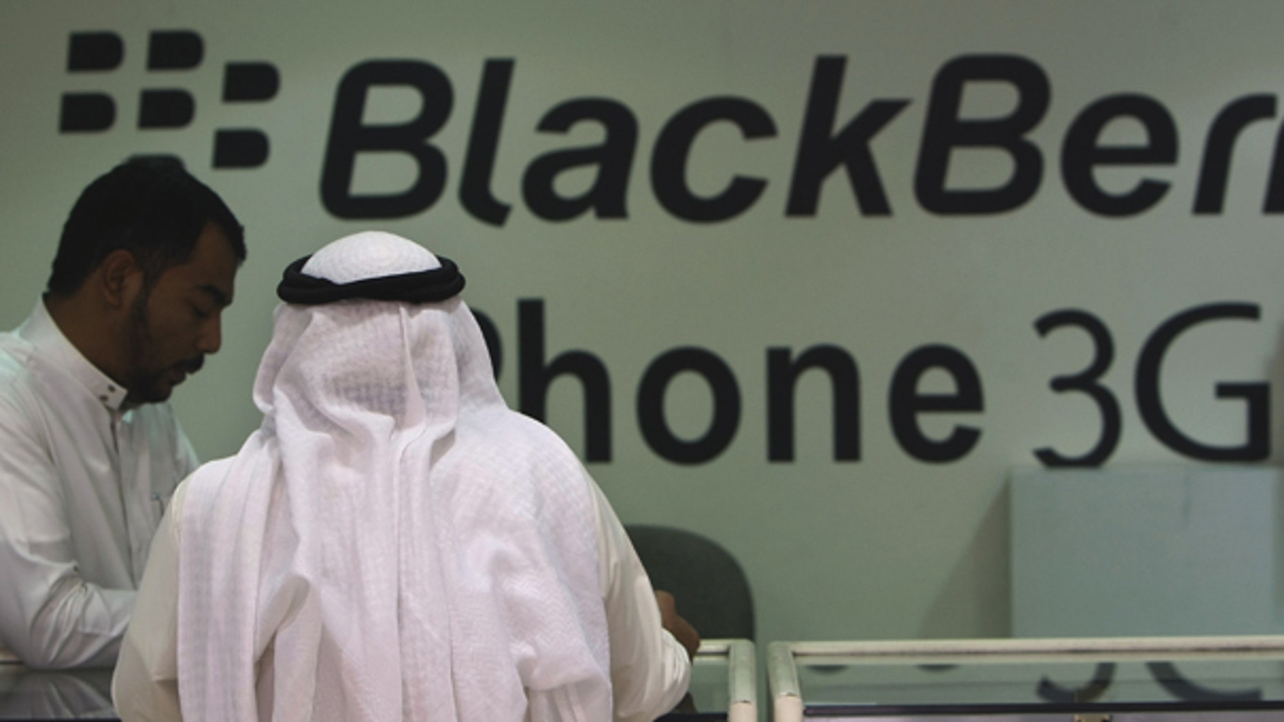 Aug. 5: A Saudi customer is served in a mobile shop at a market in the capital Riyadh, Saudi Arabia. Some Saudis tried to sell their BlackBerrys ahead of an anticipated ban on the smart phone's messenger service