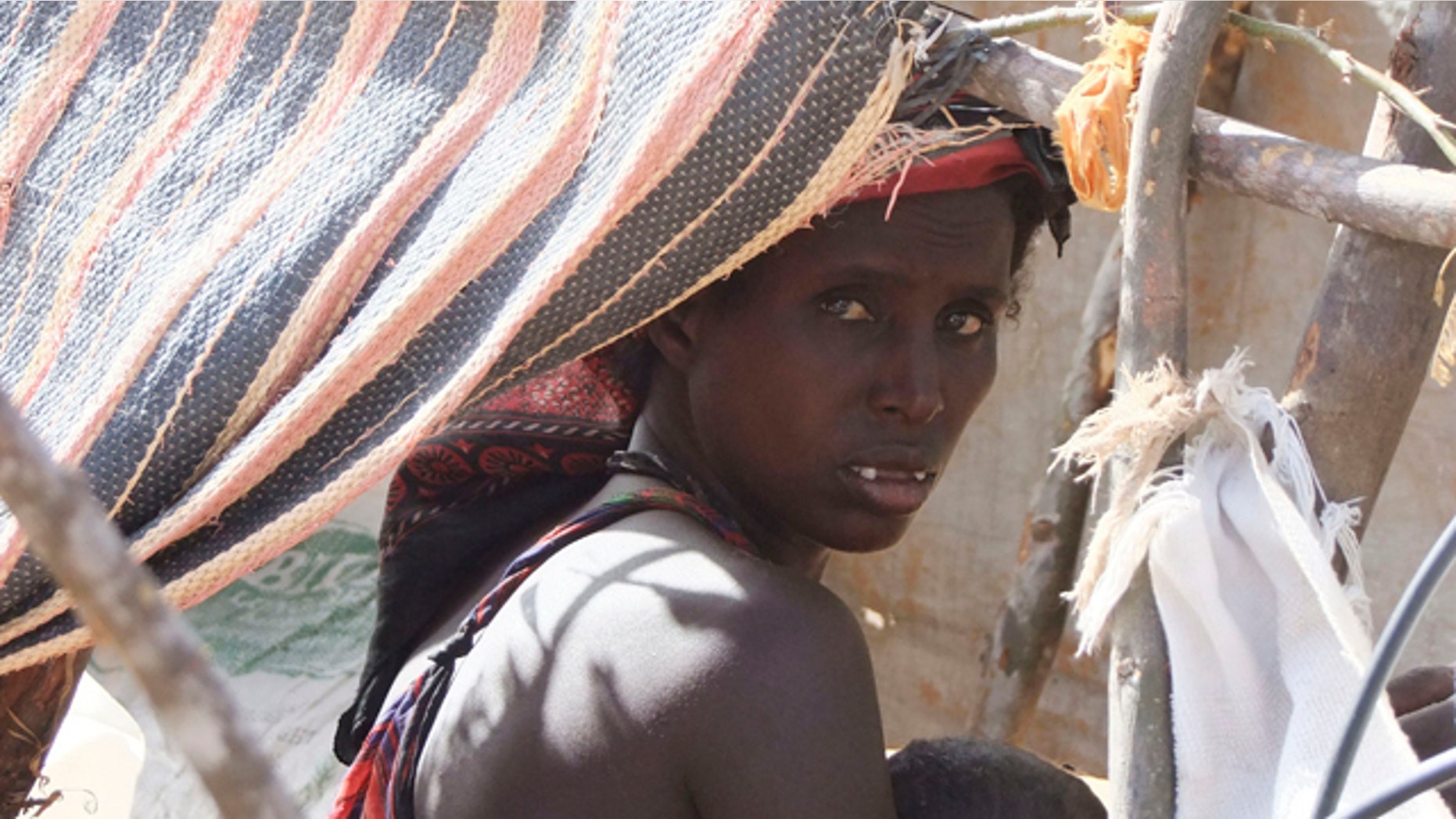 Aug. 6: A Somali woman from southern Somalia sits inside a makeshift shelter during the month of Ramadan, at a camp for displaced people in Mogadishu, Somalia.