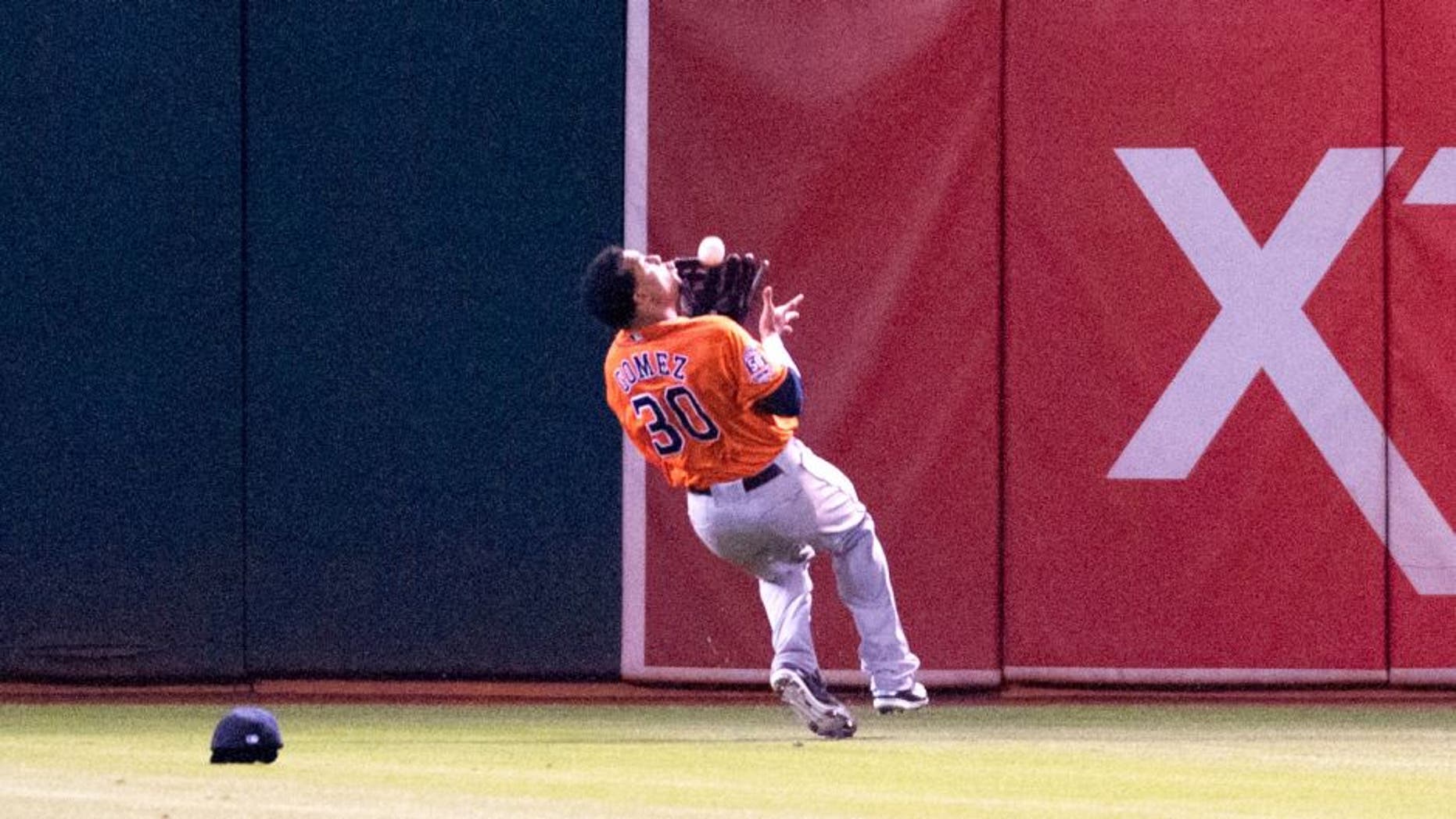Aug 6, 2015; Oakland, CA, USA; Houston Astros center fielder Carlos Gomez (30) makes an over the shoulder catch against the Oakland Athletics during the fifth inning at O.co Coliseum. Mandatory Credit: Ed Szczepanski-USA TODAY Sports