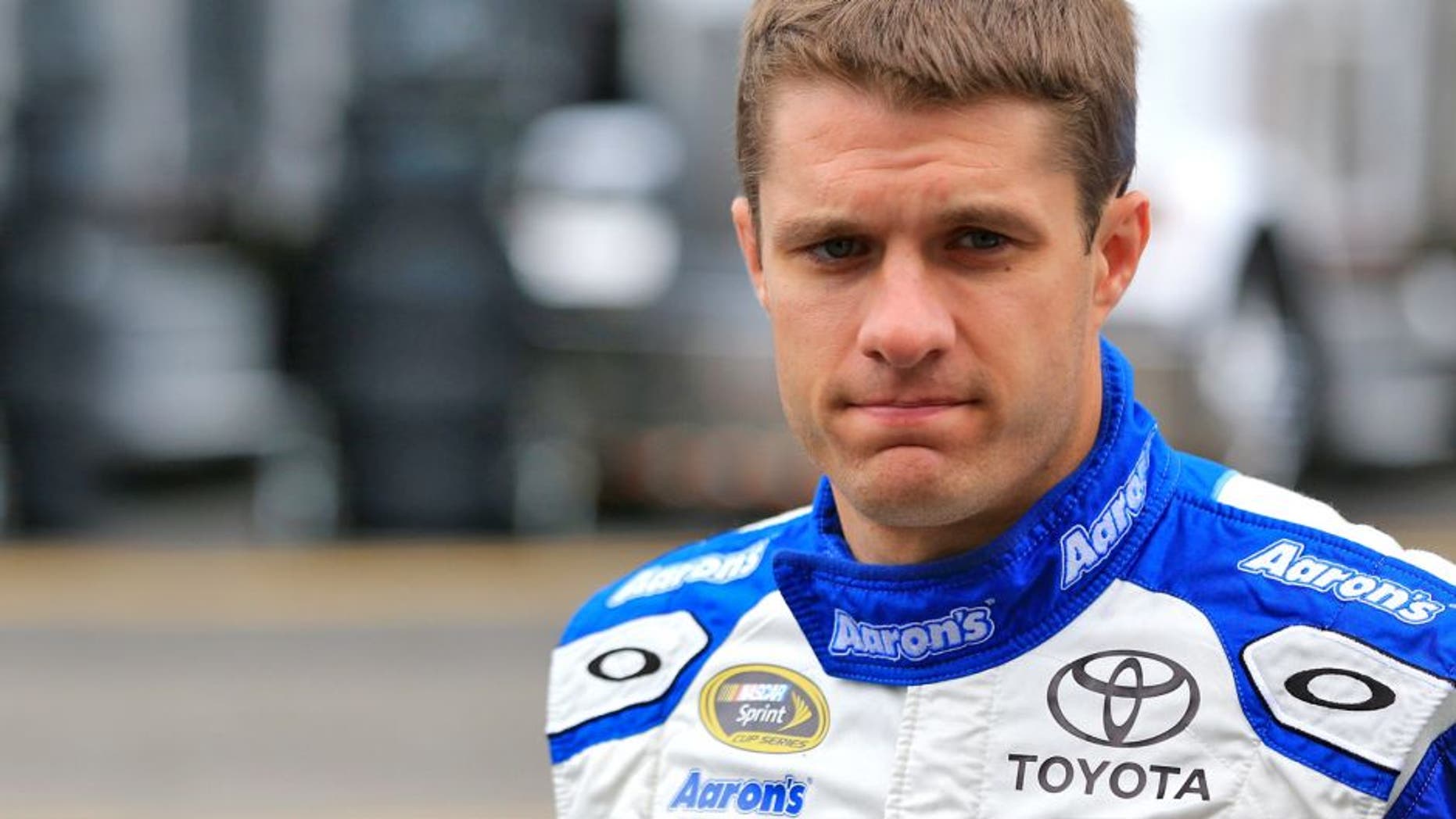 SPARTA, KY - JULY 10: David Ragan, driver of the #55 Aaron's Dream Machine Toyota, walks through the garage area during practice for the NASCAR Sprint Cup Series Quaker State 400 Presented by Advance Auto Parts at Kentucky Speedway on July 10, 2015 in Sparta, Kentucky. (Photo by Daniel Shirey/Getty Images)