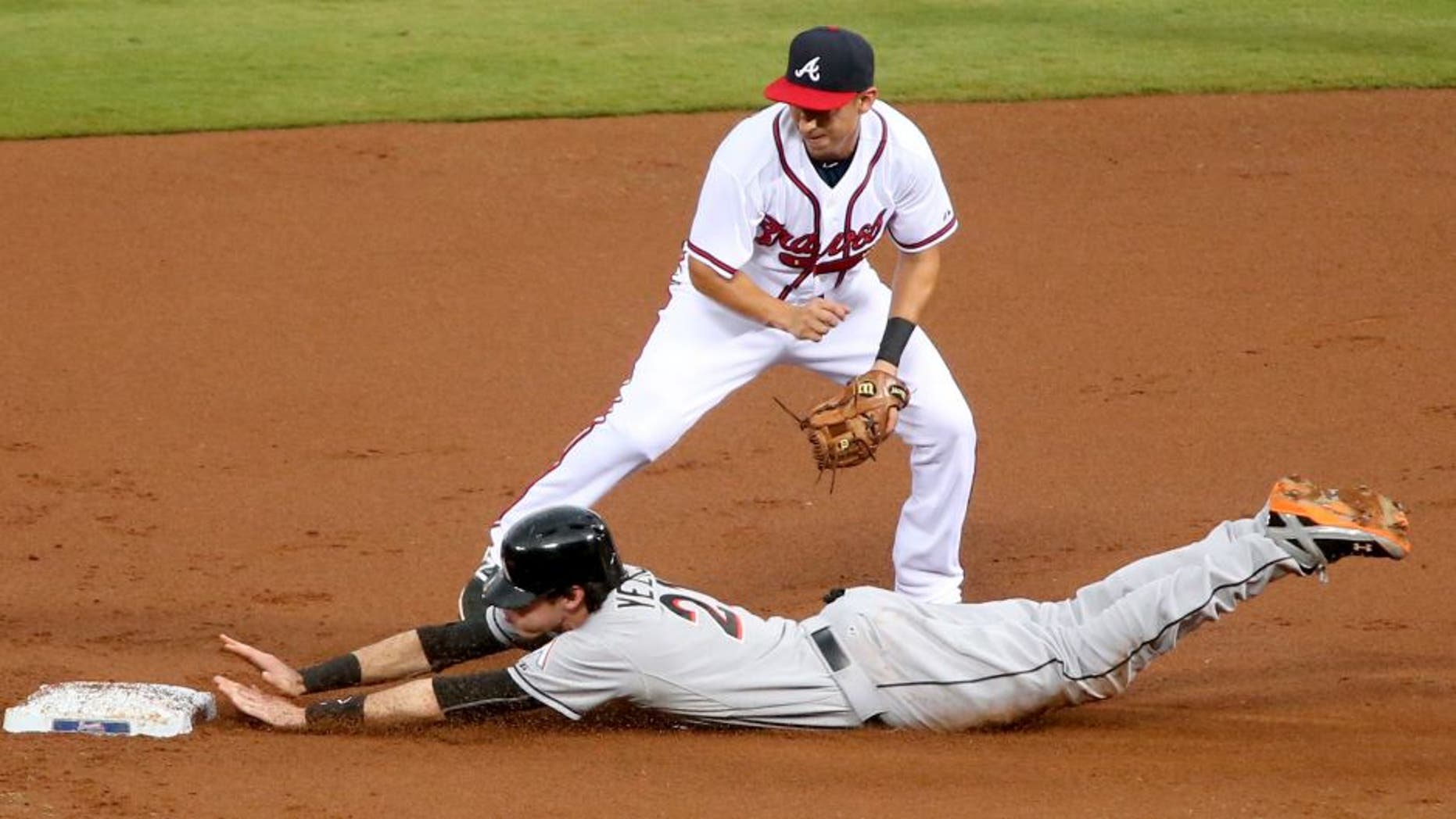 Aug 6, 2015; Atlanta, GA, USA; Miami Marlins left fielder Christian Yelich (21) steals second base ahead of the tag by Atlanta Braves shortstop Daniel Castro (11) in the first inning of their game at Turner Field. Mandatory Credit: Jason Getz-USA TODAY Sports
