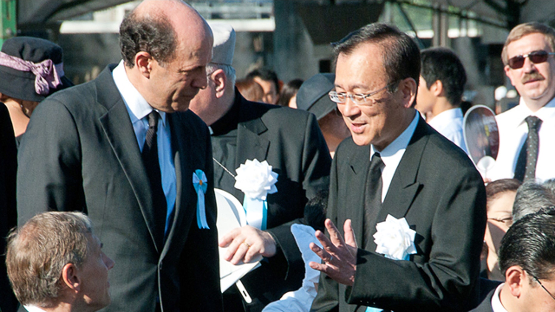Aug. 6: In this photo provided by the City of Hiroshima, U.S. Ambassador to Japan John Roos, center left, greets Hiroshima city's Mayor Tadatoshi Akiba on his arrival at the Hiroshima Peace Memorial Park to attend the 65th anniversary of the world's first atomic bombing in Hiroshima. The United States sent its first ever delegation to the ceremony marking the anniversary of the attacks.