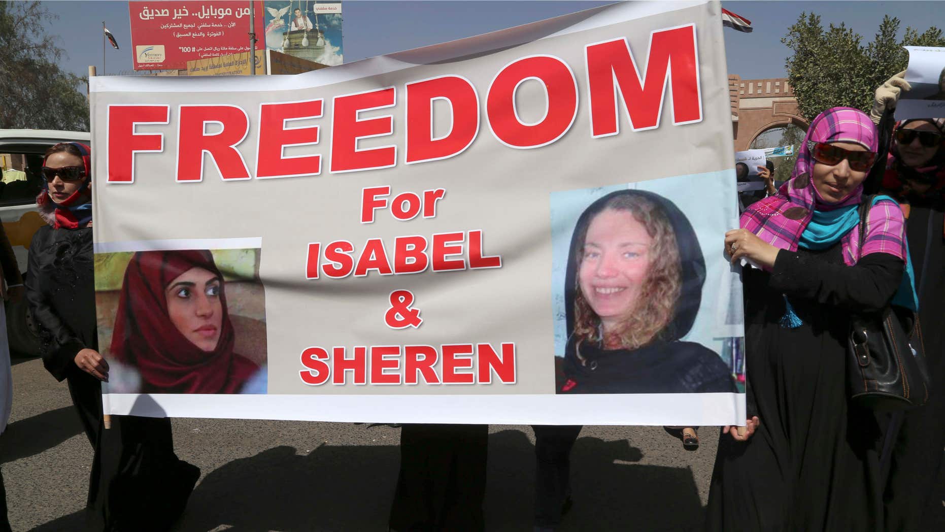 March 5, 2015: Yemeni activists hold a banner with pictures of kidnapped French Isabelle Prime, right, and her Yemeni colleague during a protest in Sanaa, Yemen.