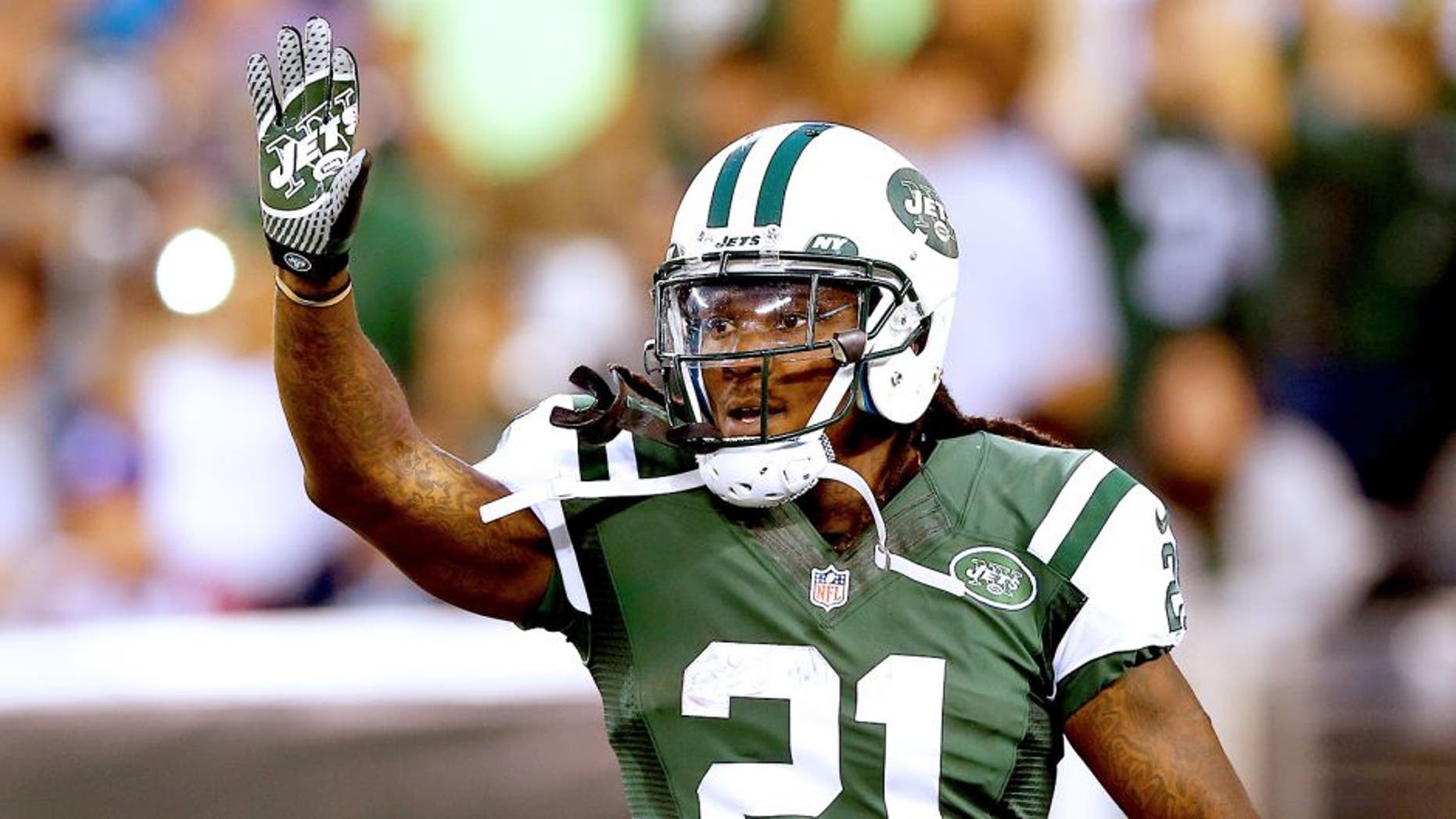 EAST RUTHERFORD, NJ - AUGUST 07: Running back Chris Johnson #21 of the New York Jets celebrates a touchdown against the Indianapolis Colts in the second quarter during a preseason game at MetLife Stadium on August 7, 2014 in East Rutherford, New Jersey. (Photo by Elsa/Getty Images)