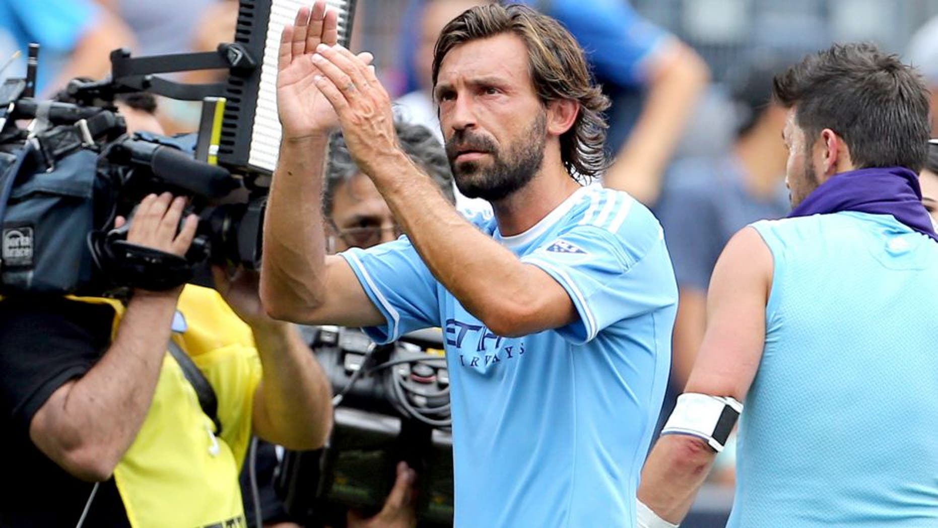Jul 26, 2015; New York, NY, USA; New York City FC midfielder Andrea Pirlo (21) leaves the field after defeating the Orlando City FC in a soccer match at Yankee Stadium. The New York City FC won 5-3. Mandatory Credit: Adam Hunger-USA TODAY Sports