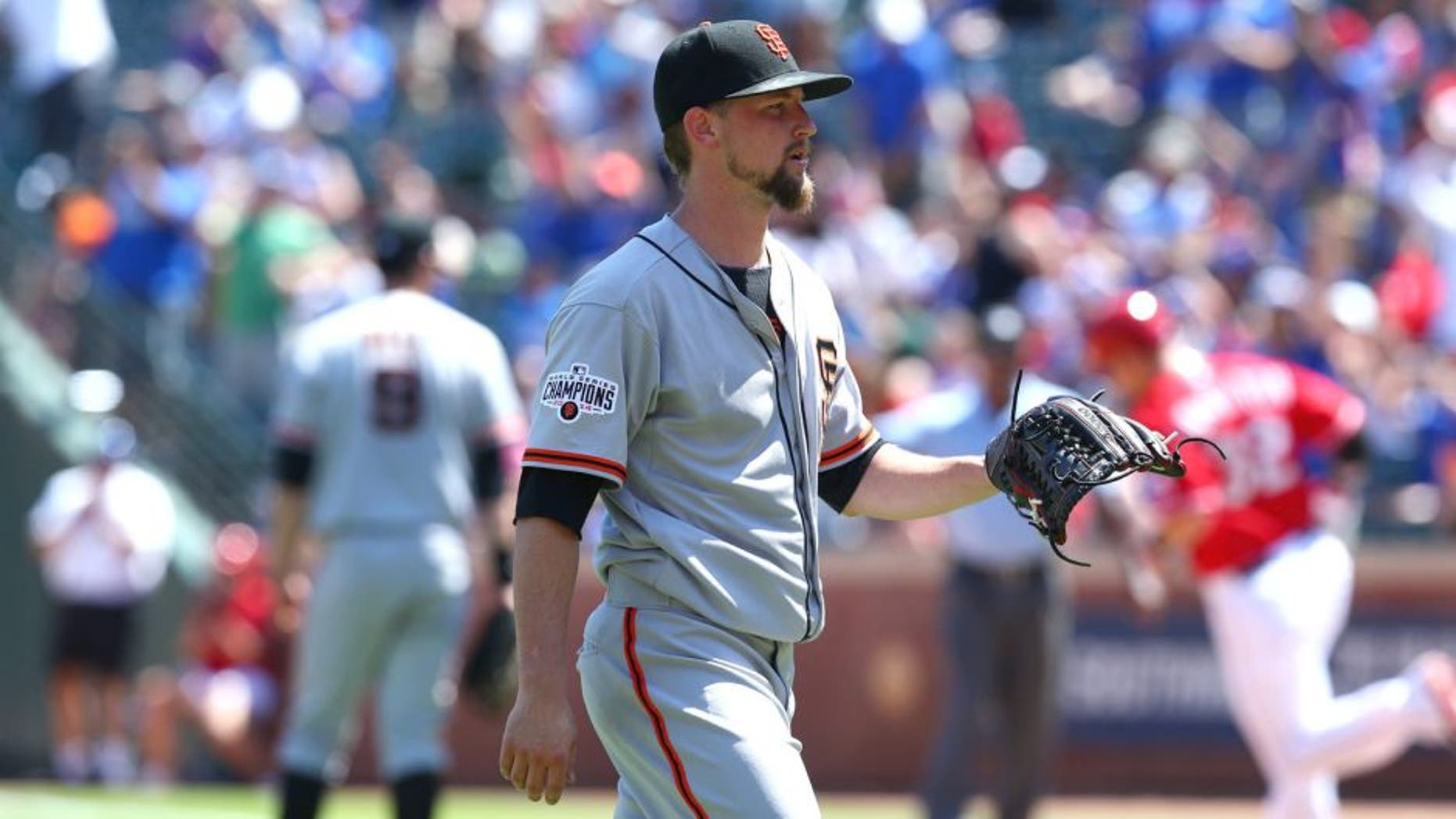 ARLINGTON, TX - AUGUST 02: Mike Leake #13 of the San Francisco Giants steps off the mound after giving up a two-run home run against Josh Hamilton #32 of the Texas Rangers in the sixth inning at Globe Life Park in Arlington on August 2, 2015 in Arlington, Texas. (Photo by Ronald Martinez/Getty Images)