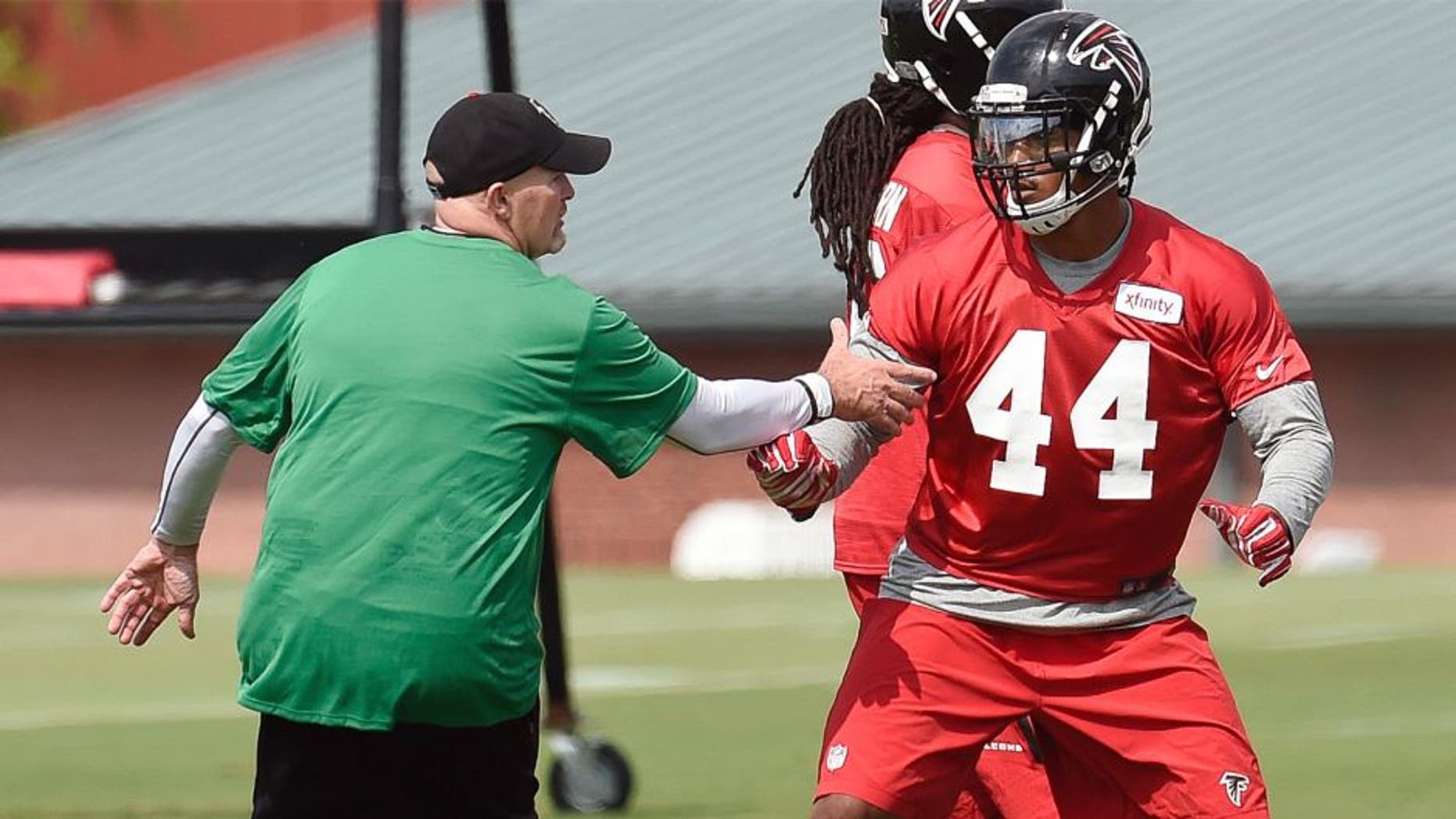 Aug 1, 2015; Atlanta, GA, USA; Atlanta Falcons head coach Dan Quinn works with defensive end Vic Beasley (44) on the field during training camp at the Flowery Branch Training Facility. Mandatory Credit: Dale Zanine-USA TODAY Sports