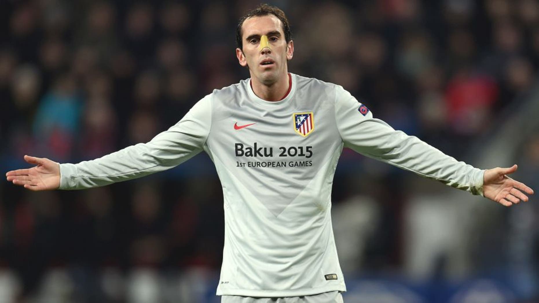 Atletico Madrid's Uruguayan defender Diego Godin reacts during the UEFA Champions League first-leg, round of 16 football match Bayer 04 Leverkusen vs Club Atletico de Madrid in Leverkusen, western Germany on February 25, 2015. AFP PHOTO / PATRIK STOLLARZ (Photo credit should read PATRIK STOLLARZ/AFP/Getty Images)