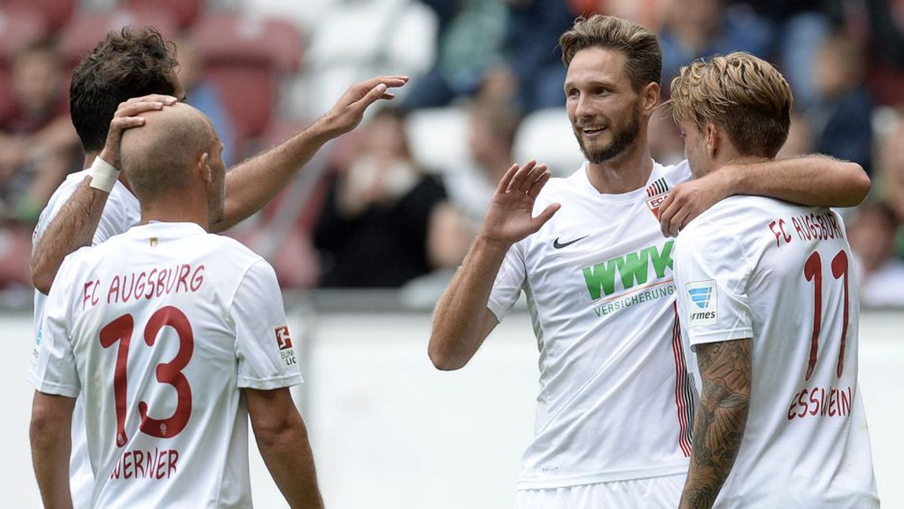 (L-R) Augsburg's Turkish midfielder Halil Altintop, Augsburg's midfielder Tobias Werner, Augsburg's Serbian striker Tim Matavz and Augsburg's midfielder Alexander Esswein celebrate after the second goal during a friendly football match between German first division Bundesliga team FC Augsburg and French first league football team FC Toulouse in Augsburg, southern Germany, on August 1, 2015. AFP PHOTO / CHRISTOF STACHE (Photo credit should read CHRISTOF STACHE/AFP/Getty Images)
