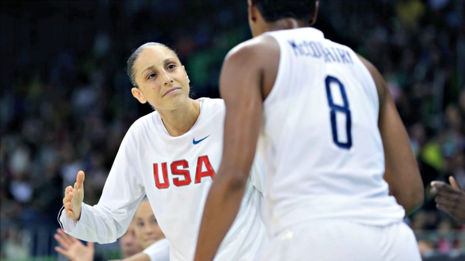 United States guard Diana Taurasi greets teammate Angel McCoughtry after a play during the second half of a women's basketball game against Senegal at the Youth Center at the 2016 Summer Olympics in Rio de Janeiro, Brazil, Sunday, Aug. 7, 2016. The United States defeated Senegal 121-56. (AP Photo/Carlos Osorio)
