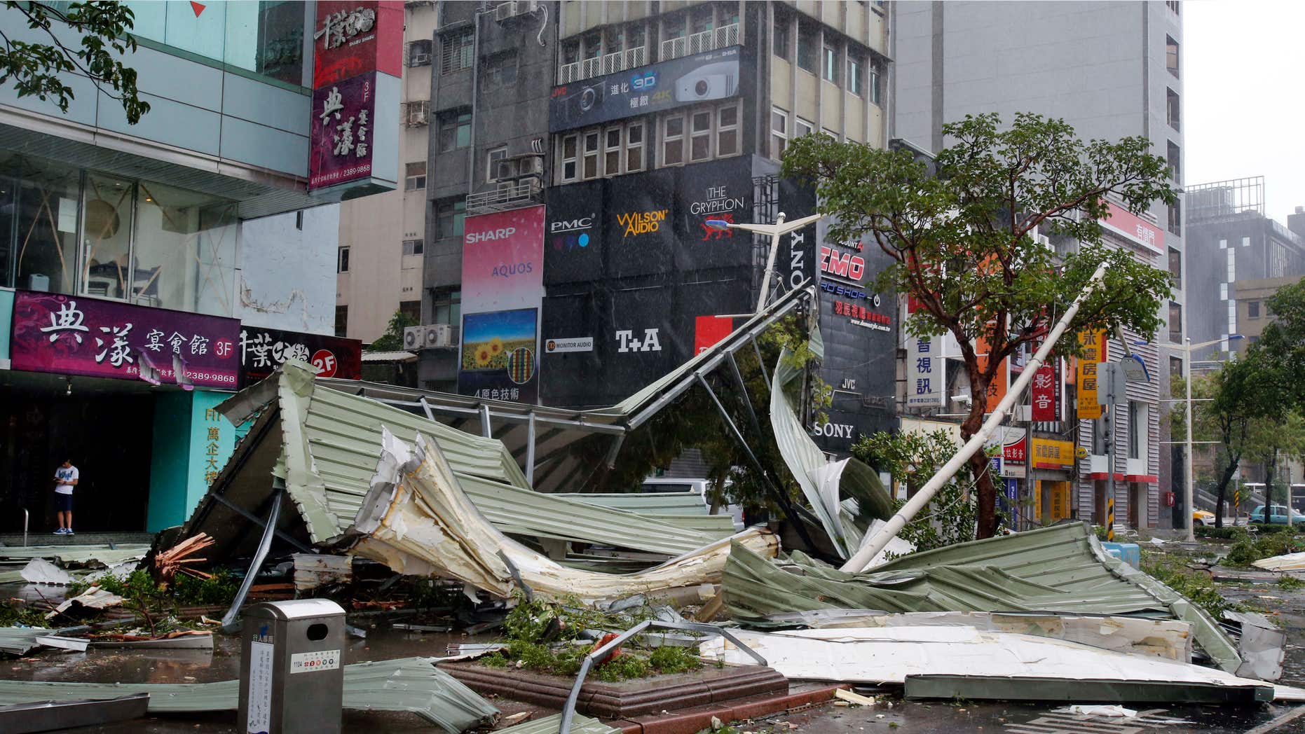 Aug. 8, 2015: A street corner is filled with a mangled rooftop brought down by strong winds from Typhoon Soudelor in Taipei, Taiwan.