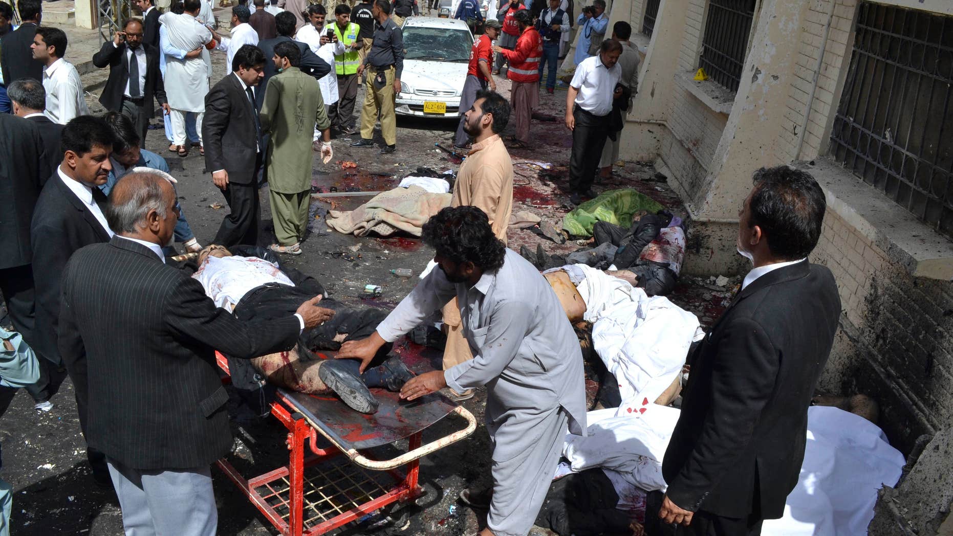 Aug. 8, 2016: People help victims of a bomb blast in Quetta, Pakistan.