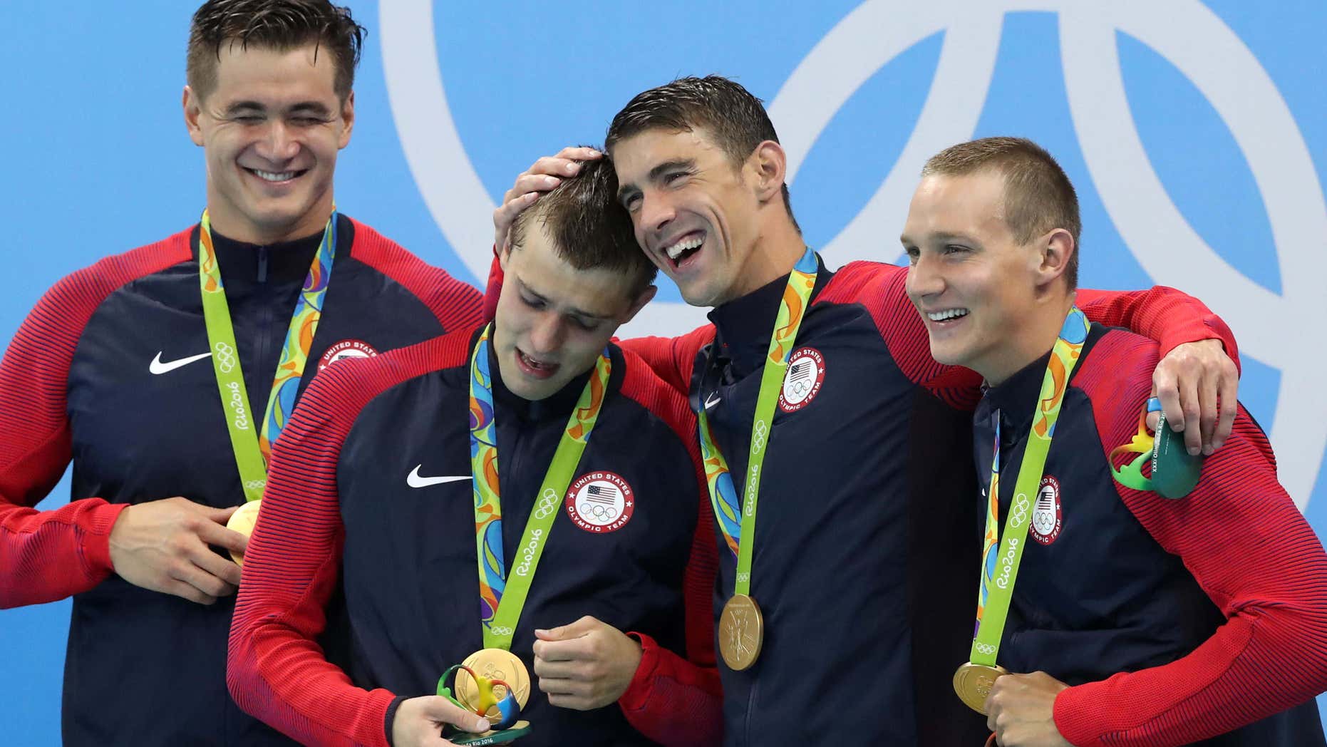The United States team from left, Nathan Adrian, Ryan Held, Michael Phelps and Caeleb Dressel celebrate on the medal ceremony after winning the gold medal in the men's 4x100-meter freestyle relay during the swimming competitions at the 2016 Summer Olympics, Monday, Aug. 8, 2016, in Rio de Janeiro, Brazil.