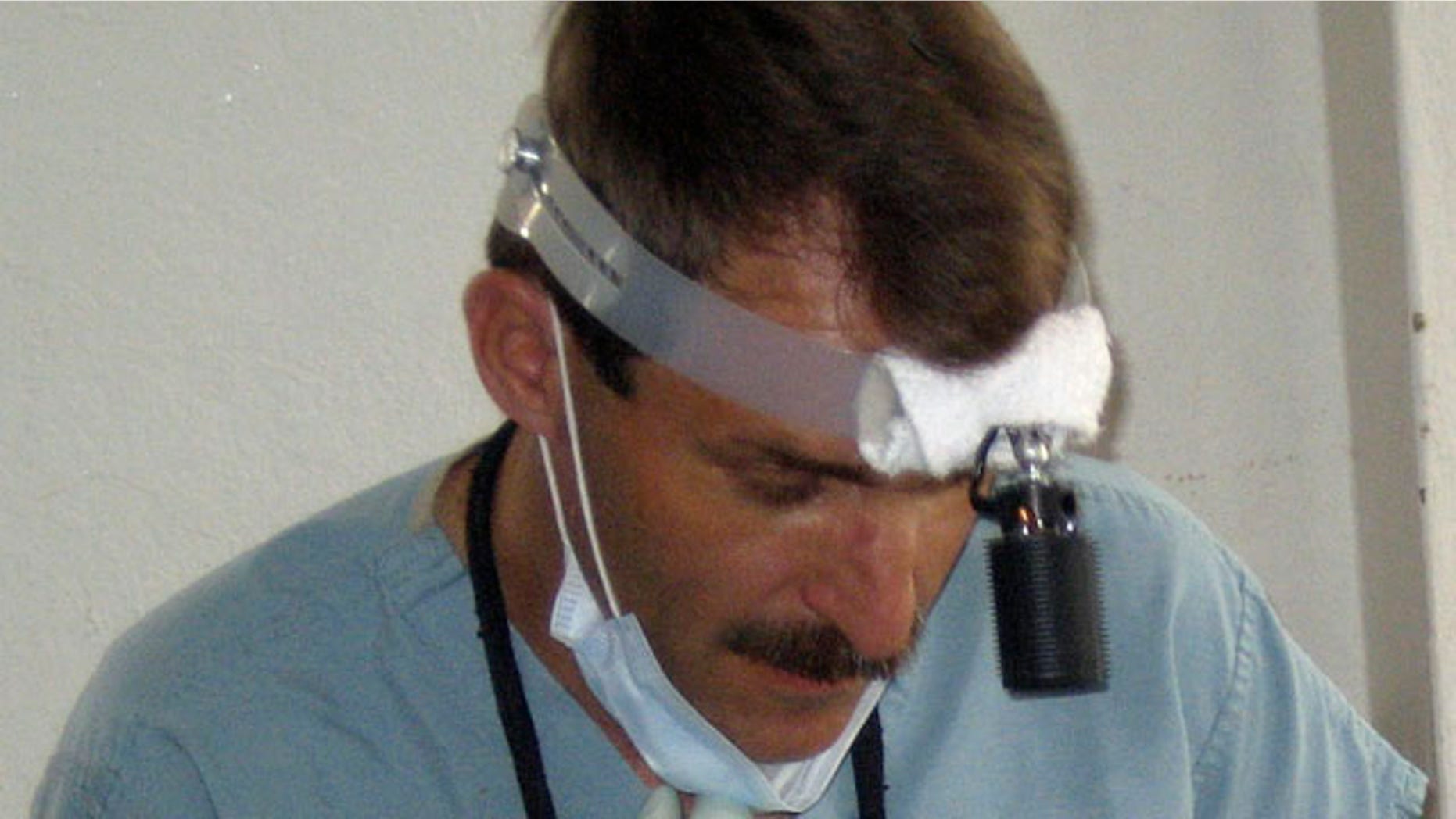 In this 2007 photo released by Kay Shaw of Global Dental Relief, a Denver-based group that sends teams of dentists around the globe, Dr. Thomas Grams, 51, formerly of Durango, Colo., works with a patient in Kathmandu, Nepal.