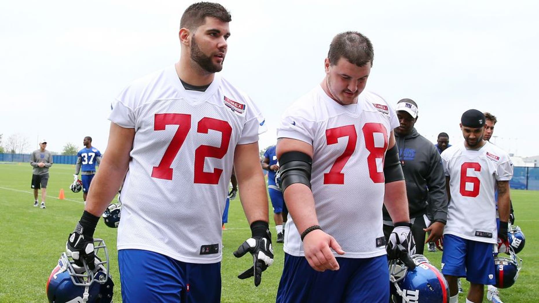 EAST RUTHERFORD, NJ - MAY 11: Justin Pugh #72 and Eric Herman #78 of the New York Giants walk off the field after the New York Giants Rookie Camp on May 11, 2013 at the Timex Performance Center in East Rutherford, New Jersey. (Photo by Elsa/Getty Images)