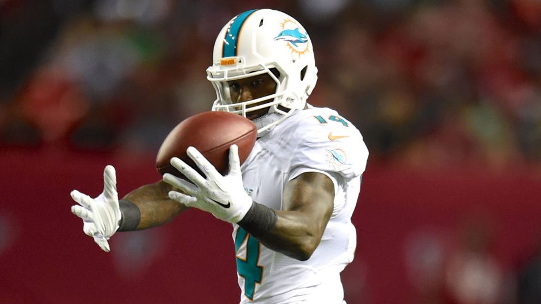 Aug 8, 2014; Atlanta, GA, USA; Miami Dolphins wide receiver Jarvis Landry (14) makes a catch in front of Atlanta Falcons cornerback Javier Arenas (28) during the second quarter at the Georgia Dome. Mandatory Credit: Dale Zanine-USA TODAY Sports