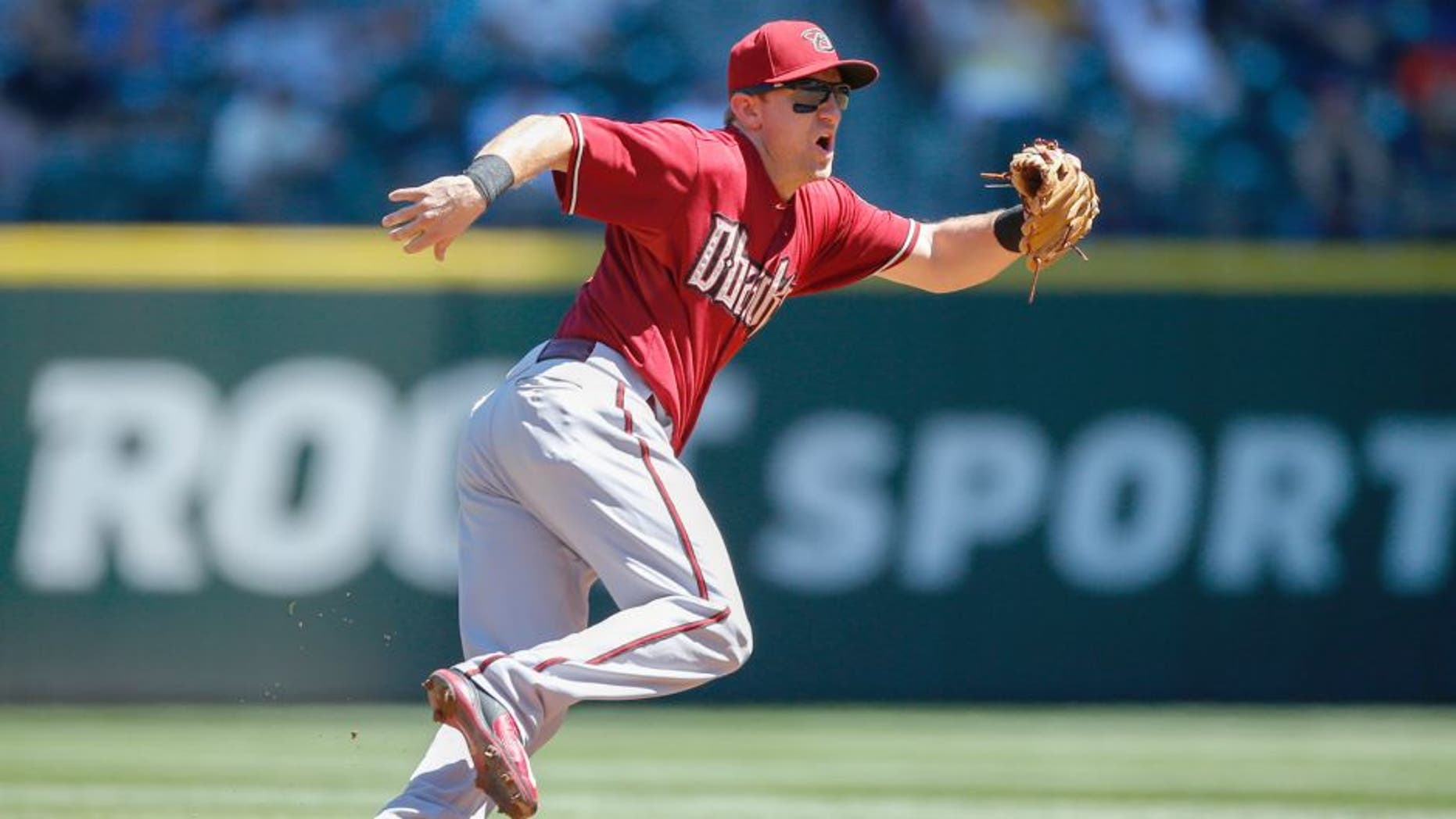 SEATTLE, WA - JULY 29: Shortstop Cliff Pennington #4 of the Arizona Diamondbacks fields a grounder against the Seattle Mariners at Safeco Field on July 29, 2015 in Seattle, Washington. (Photo by Otto Greule Jr/Getty Images)