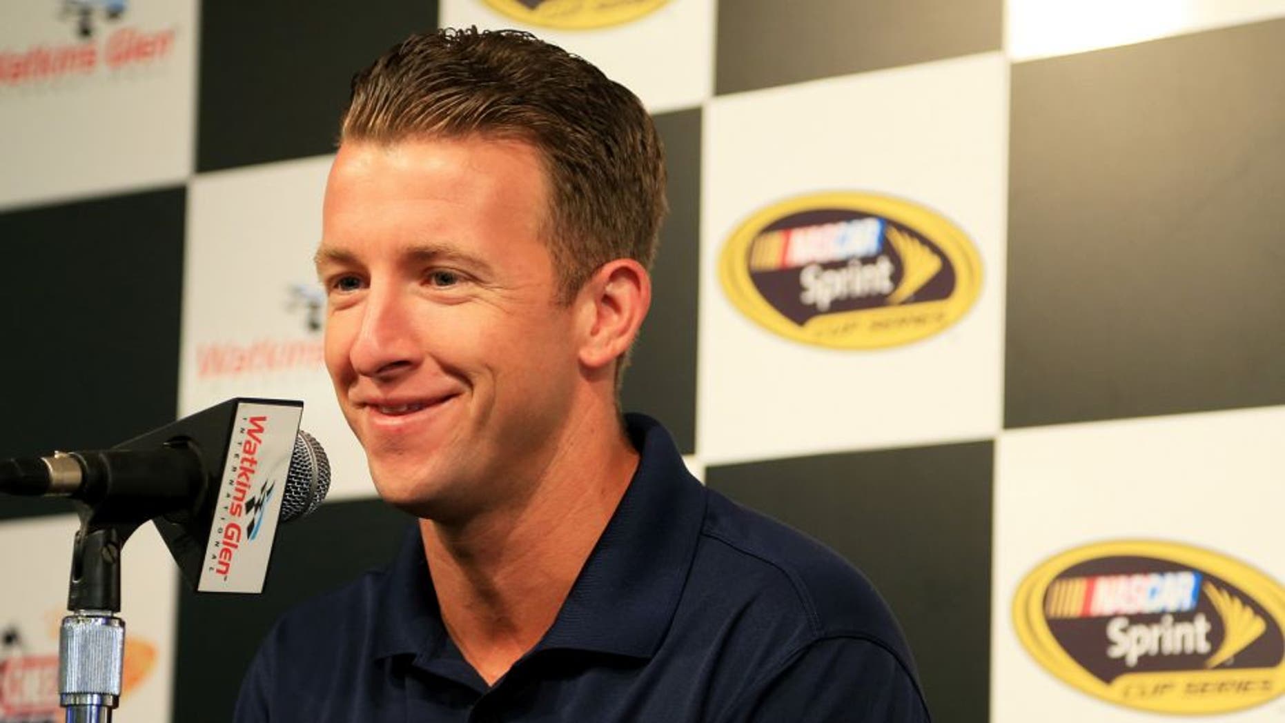 WATKINS GLEN, NY - AUGUST 07: AJ Allmendinger, driver of the #47 Kroger/Bush's Beans Chevrolet, speaks to the media during a press conference prior to practice for the NASCAR Sprint Cup Series Cheez-It 355 at Watkins Glen International on August 7, 2015 in Watkins Glen, New York. (Photo by Daniel Shirey/Getty Images)