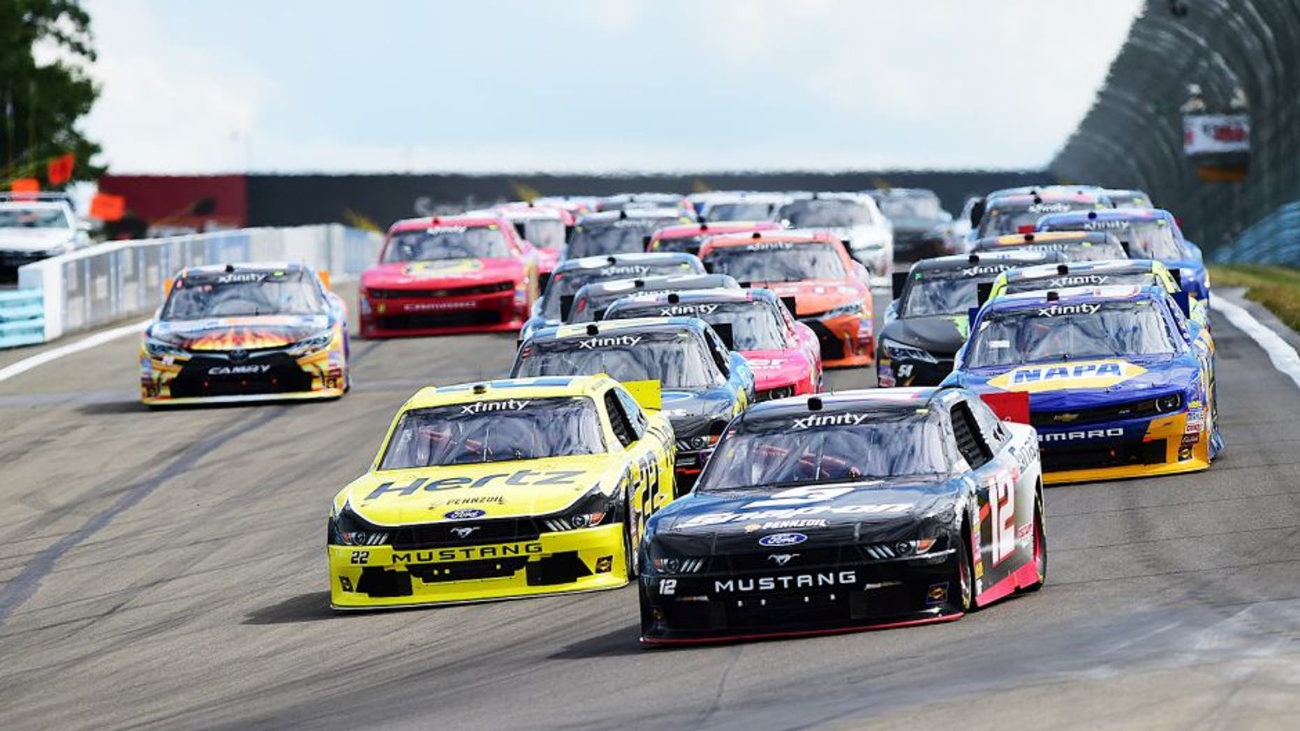 WATKINS GLEN, NY - AUGUST 08: Joey Logano, driver of the #12 Snap-on Ford, and Brad Keselowski, driver of the #22 Hertz Ford, lead a pack of cars during the NASCAR XFINITY Series Zippo 200 at Watkins Glen International on August 8, 2015 in Watkins Glen, New York. (Photo by Jared C. Tilton/NASCAR via Getty Images)