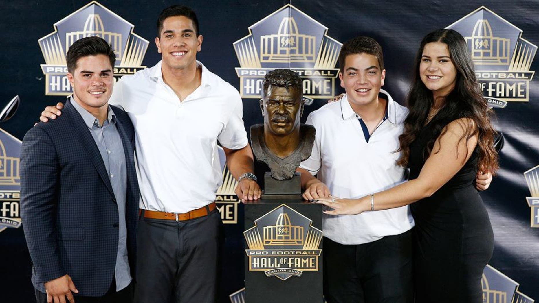 CANTON, OH - AUGUST 8: Junior Seau's children pose with his bust during the NFL Hall of Fame induction ceremony at Tom Benson Hall of Fame Stadium on August 8, 2015 in Canton, Ohio. (Photo by Joe Robbins/Getty Images)