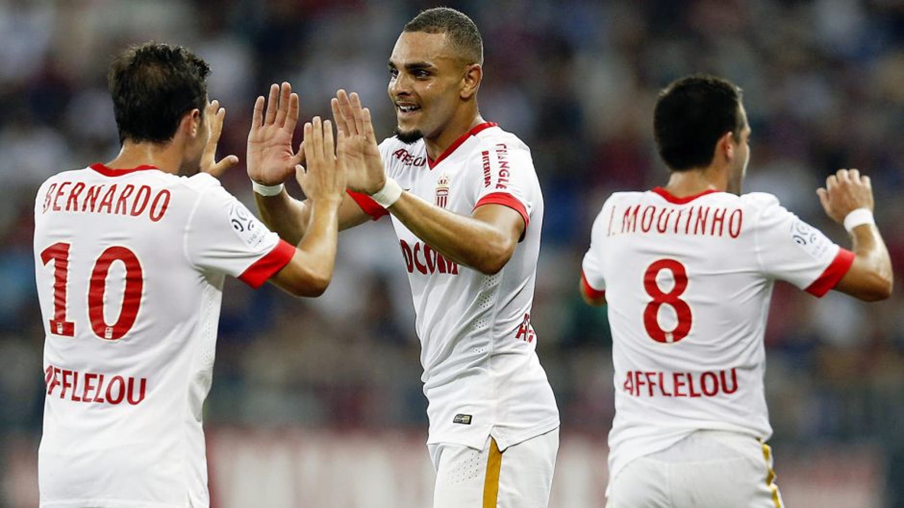 Monaco's French defender Layvin Kurzawa (C) celebrates with Portuguese midfielders Bernardo Silva (L) and Joao Moutinho after scoring his team's second goal during the French L1 football match between Nice and Monaco at the Allianz Riviera stadium in Nice, southeastern France, on August 8, 2015. AFP PHOTO / VALERY HACHE (Photo credit should read VALERY HACHE/AFP/Getty Images)