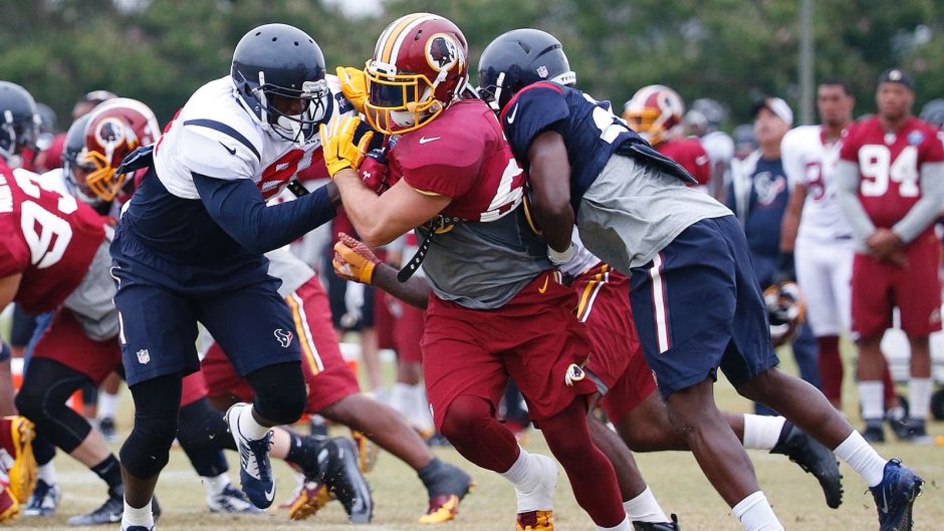 Aug 7, 2015; Richmond, VA, USA; Washington Redskins inside linebacker Will Compton (51) participates in drills with Houston Texans tight end Anthony Denham (81) and Texans defensive back Andre Hal (29) during morning practice as part of day eight of training camp at Bon Secours Washington Redskins Training Center. Mandatory Credit: Amber Searls-USA TODAY Sports