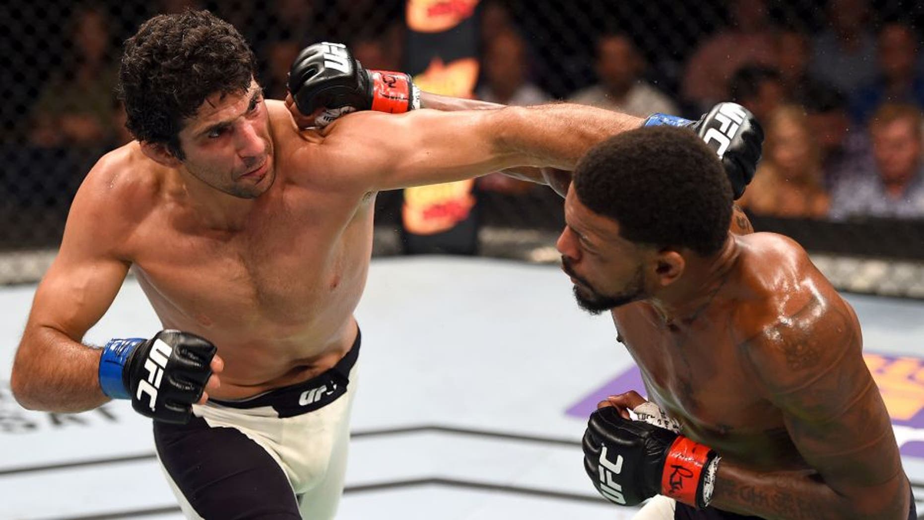 NASHVILLE, TN - AUGUST 08: (L-R) Beneil Dariush punches Michael Johnson in their lightweight bout during the UFC Fight Night event at Bridgestone Arena on August 8, 2015 in Nashville, Tennessee. (Photo by Josh Hedges/Zuffa LLC/Zuffa LLC via Getty Images)