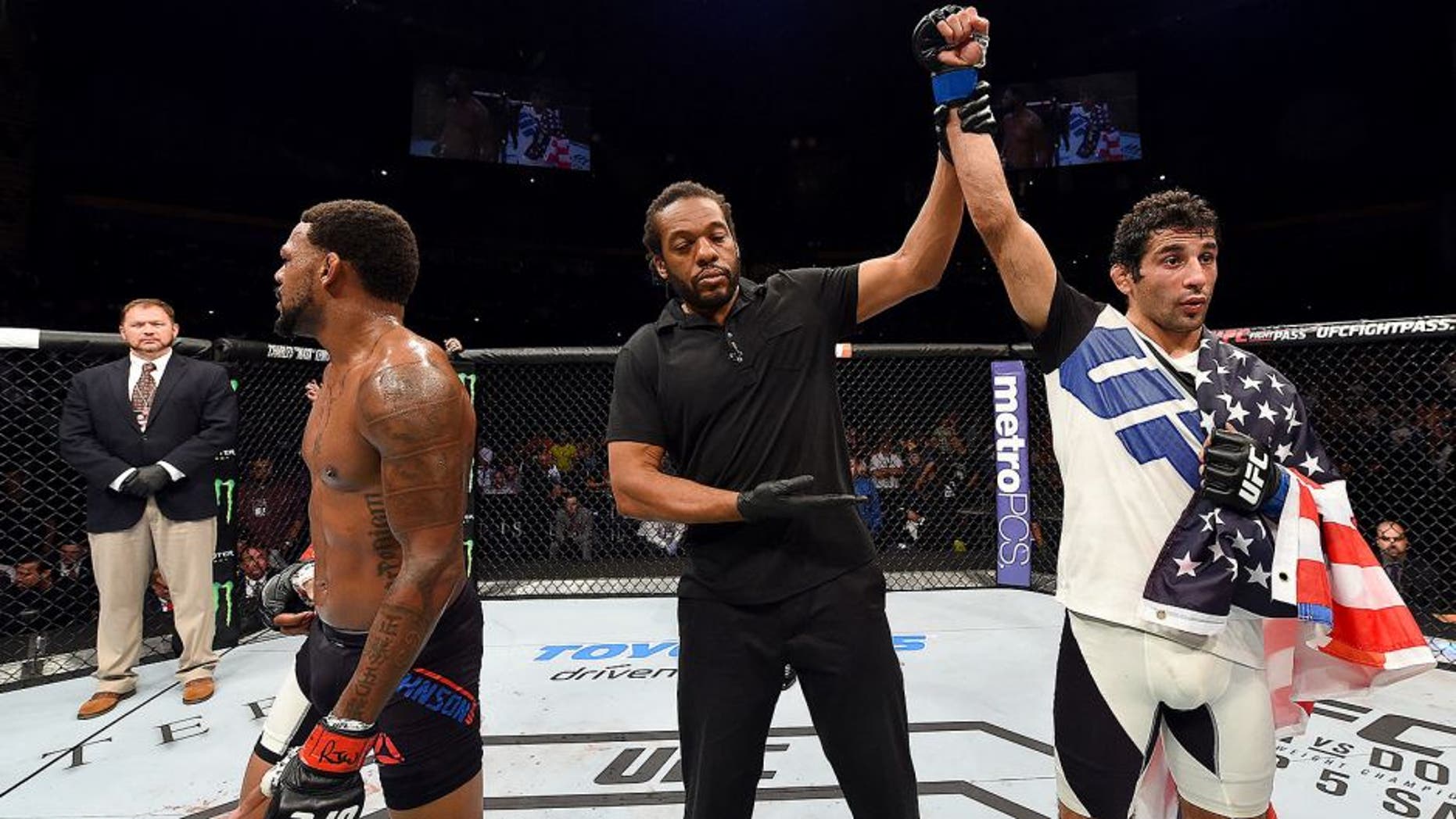 NASHVILLE, TN - AUGUST 08: (R-L) Beneil Dariush celebrates after defeating Michael Johnson in their lightweight bout during the UFC Fight Night event at Bridgestone Arena on August 8, 2015 in Nashville, Tennessee. (Photo by Josh Hedges/Zuffa LLC/Zuffa LLC via Getty Images)