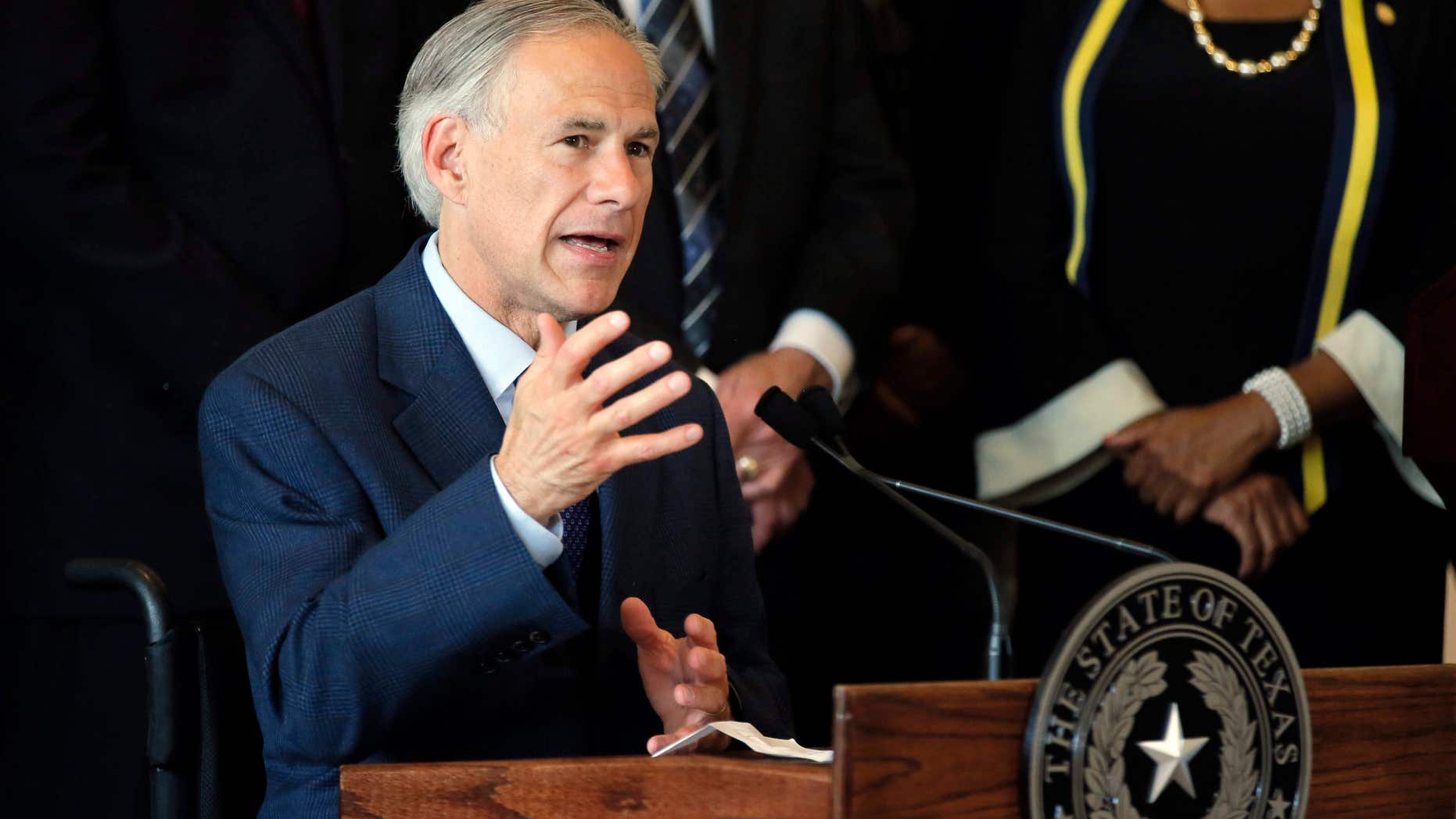 FILE - In this Friday, July 8, 2016 file photo, Texas Gov. Greg Abbott, right, responds to questions about the police shootings during a news conference at City Hall in Dallas.