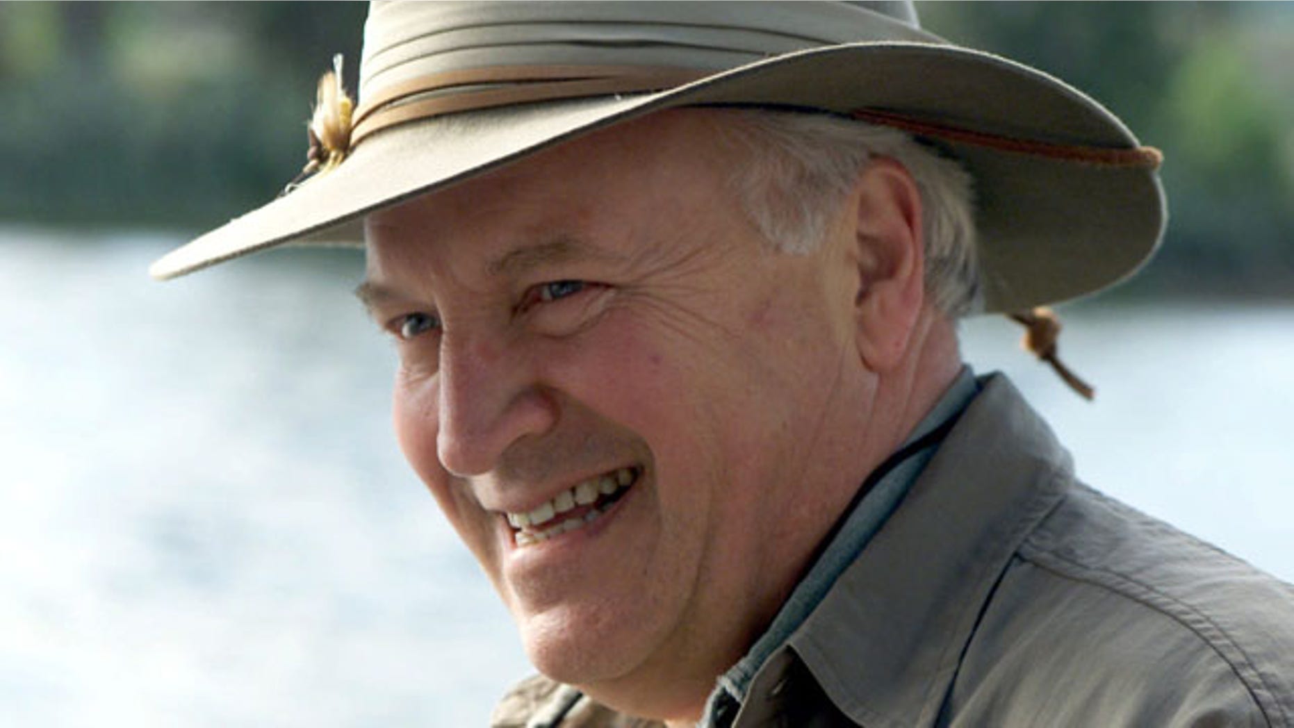 In this July 8, 2001, file photo released by The White House, Vice President Dick Cheney smiles while fly-fishing on the Snake River with his family in his home state of Wyoming.