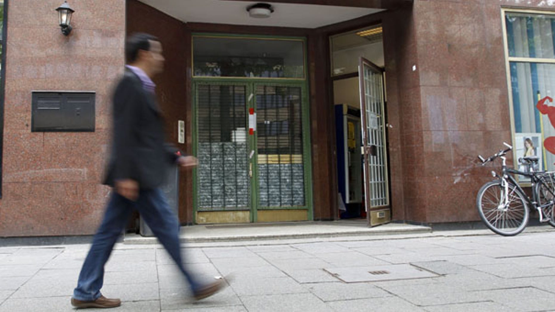 Aug. 9: A passerby is walking in front of the sealed front doors of the Hamburg mosque once frequented by some of the Sept. 11 attackers, and which German authorities said they believed was a meeting-point for Islamic radicals again.