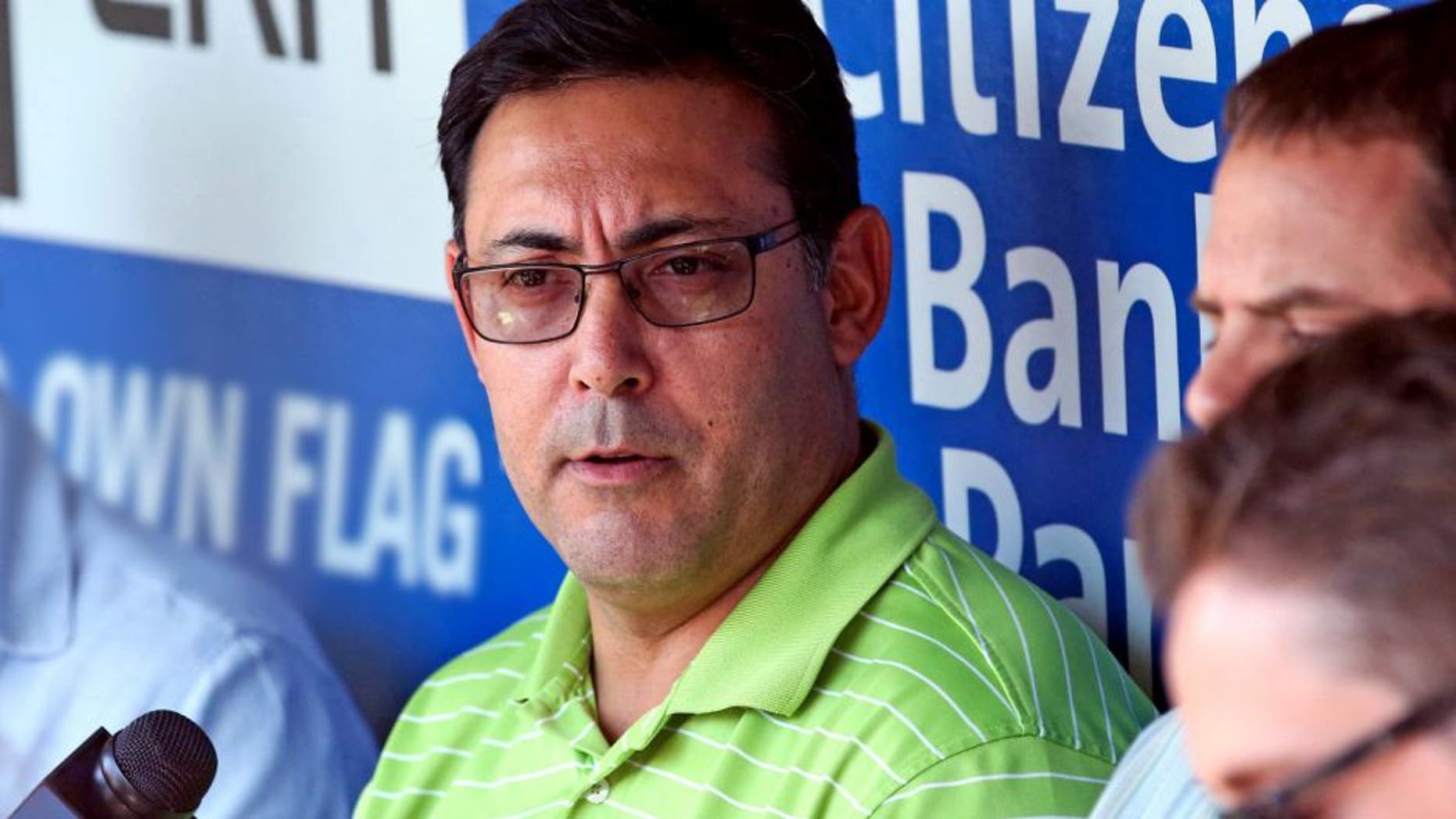 Jul 25, 2014; Philadelphia, PA, USA; Philadelphia Phillies general manager Ruben Amaro, Jr. talks with reporters during batting practice before a game against the Arizona Diamondbacks at Citizens Bank Park. Mandatory Credit: Bill Streicher-USA TODAY Sports