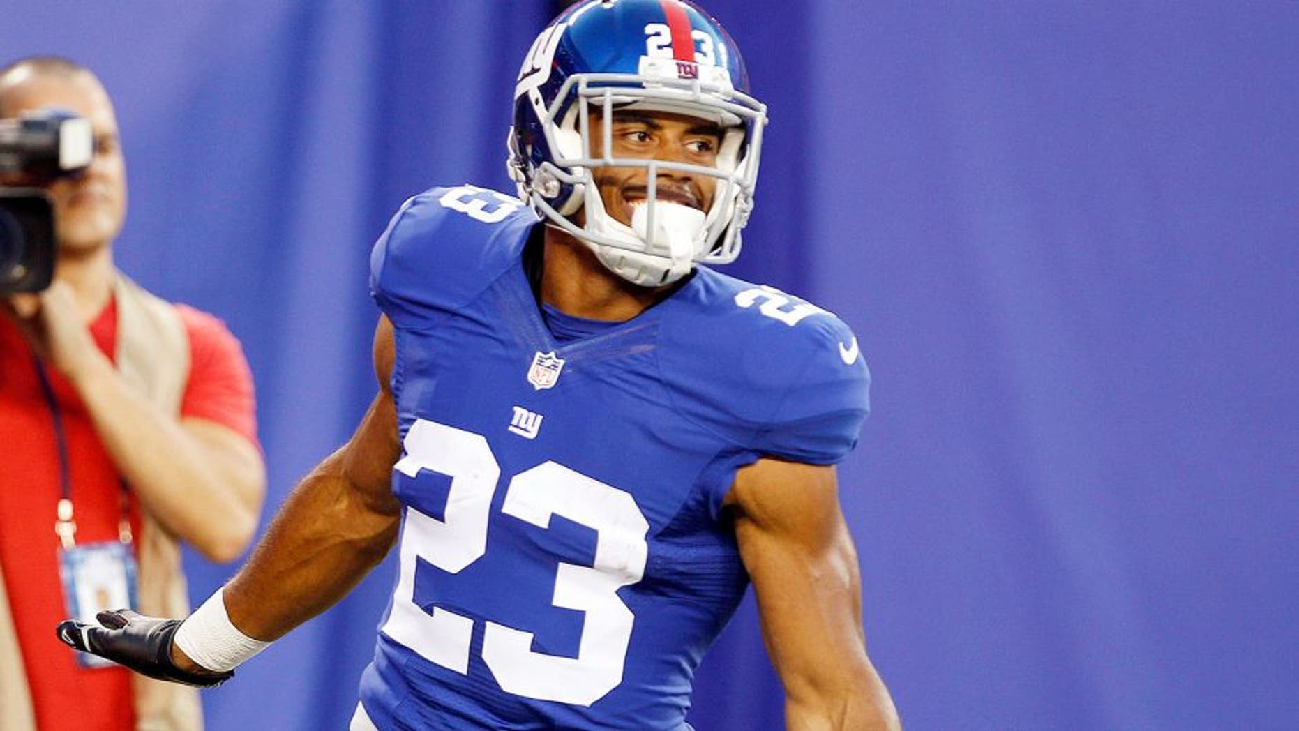 Aug 9, 2014; East Rutherford, USA; New York Giants running back Rashad Jennings (23) celebrates after scoring a touchdown against the Pittsburgh Steelers during the preseason game at MetLife Stadium. Mandatory Credit: William Perlman/THE STAR-LEDGER via USA TODAY Sports