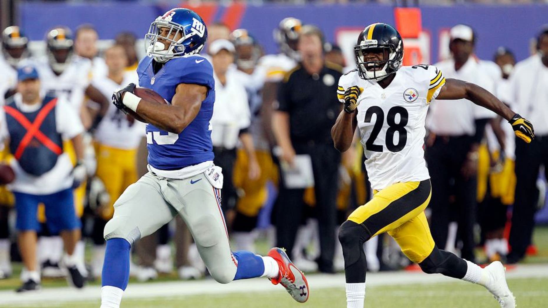 Aug 9, 2014; East Rutherford, USA; New York Giants running back Rashad Jennings (23) scores a touchdown past Pittsburgh Steelers cornerback Cortez Allen (28) during the preseason game at MetLife Stadium. Mandatory Credit: William Perlman/THE STAR-LEDGER via USA TODAY Sports