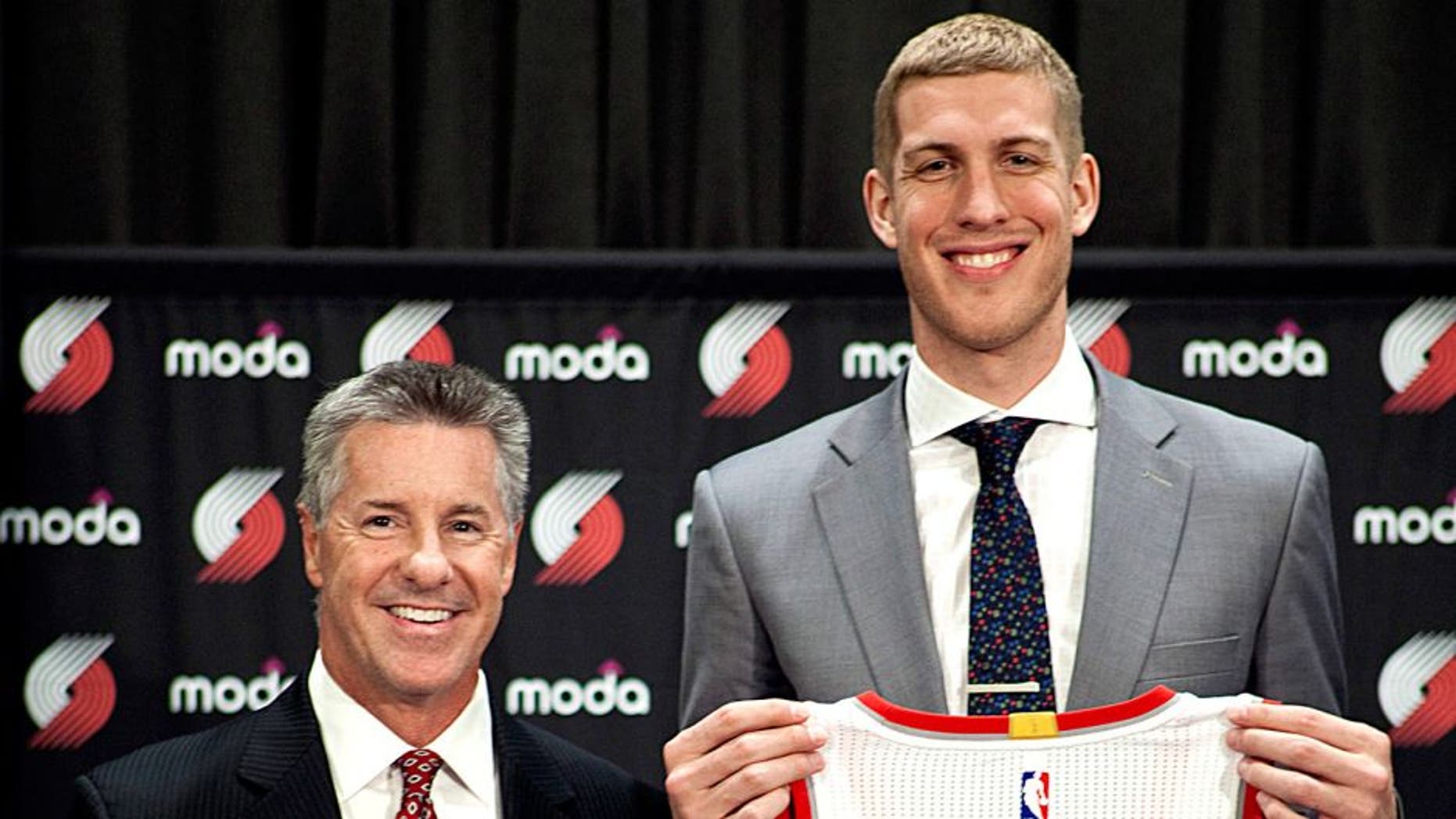 PORTLAND, OR - JUNE 29: Mason Plumlee #24 of the Portland Trail Blazers is introduced by GM Neil Oshay and head coach Terry Stotts during a press conference on June 29, 2015 at the practice facility in Portland, Oregon. NOTE TO USER: User expressly acknowledges and agrees that, by downloading and or using this photograph, User is consenting to the terms and conditions of the Getty Images License Agreement. Mandatory Copyright Notice: Copyright 2015 NBAE (Photo by Cameron Browne/NBAE via Getty Images)
