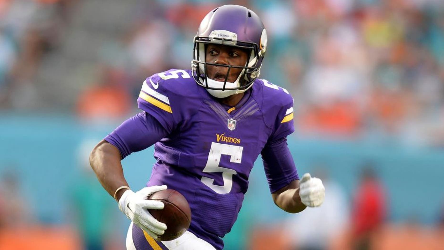 Dec 21, 2014; Miami Gardens, FL, USA; Minnesota Vikings quarterback Teddy Bridgewater (5) scrambles during the second half against the Miami Dolphins at Sun Life Stadium. The Dolphins won 37-35. Mandatory Credit: Steve Mitchell-USA TODAY Sports