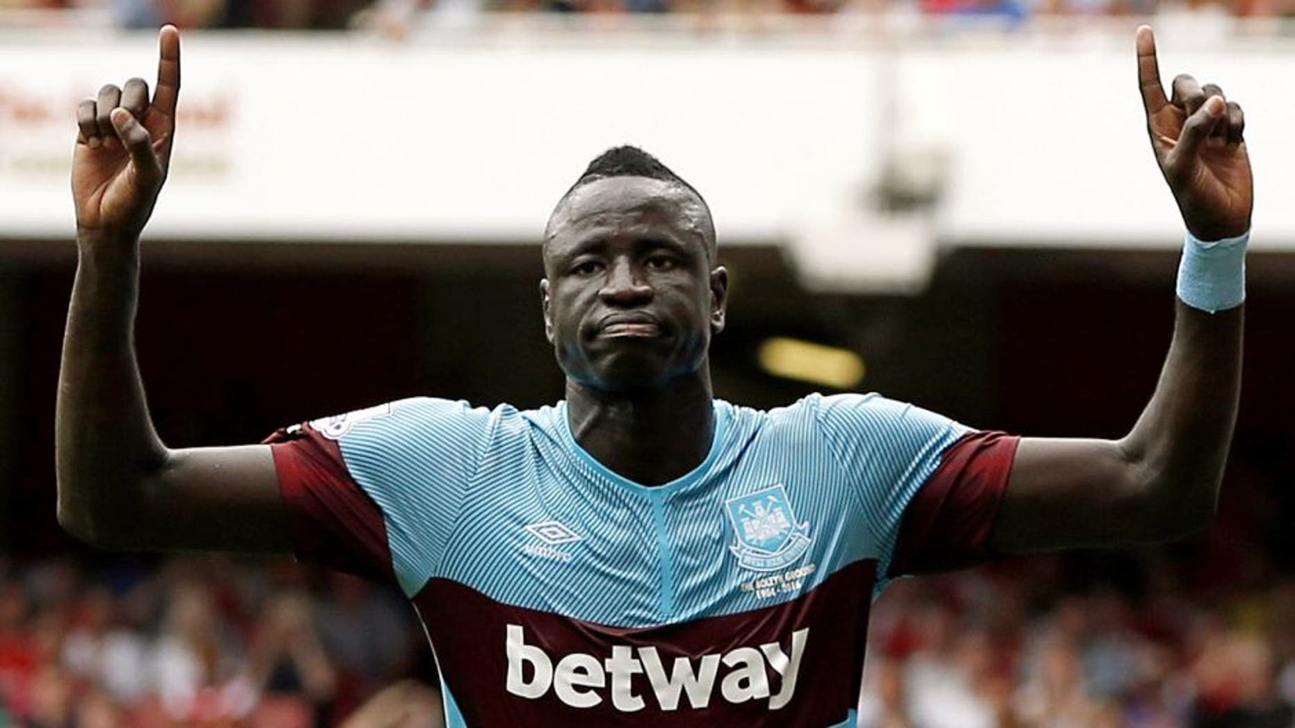 West Ham United's Senegalese midfielder Cheikhou Kouyate celebrates scoring the opening goal of the English Premier League football match between Arsenal and West Ham United at the Emirates Stadium in London on August 9, 2015. AFP PHOTO / ADRIAN DENNIS RESTRICTED TO EDITORIAL USE. No use with unauthorized audio, video, data, fixture lists, club/league logos or 'live' services. Online in-match use limited to 75 images, no video emulation. No use in betting, games or single club/league/player publications. (Photo credit should read ADRIAN DENNIS/AFP/Getty Images)