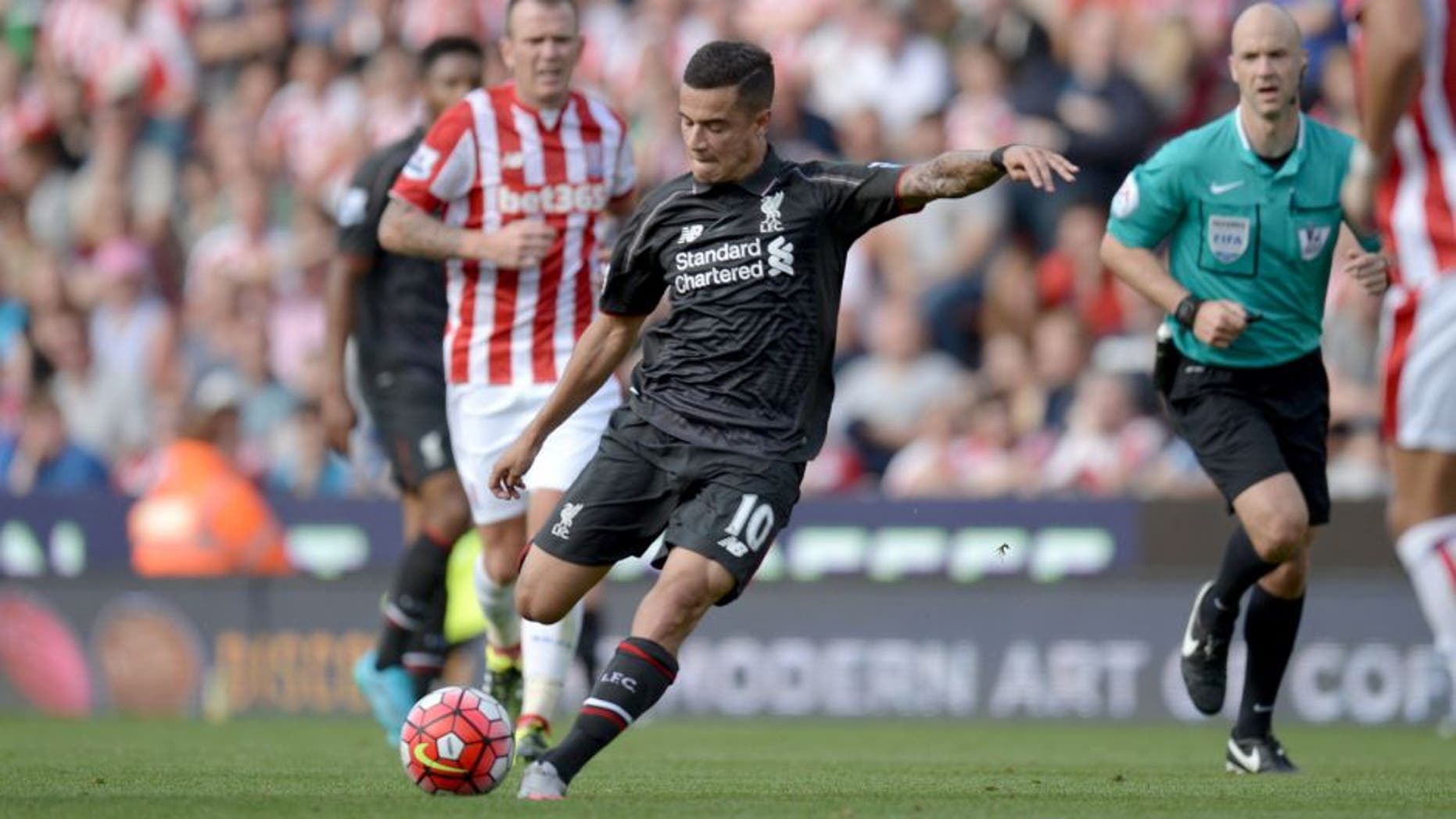 Liverpool's Brazilian midfielder Philippe Coutinho shoots to score the opening goal of the English Premier League football match between Stoke City and Liverpool at the Britannia Stadium in Stoke-on-Trent, central England on August 9, 2015. AFP PHOTO / OLI SCARFF RESTRICTED TO EDITORIAL USE. No use with unauthorized audio, video, data, fixture lists, club/league logos or 'live' services. Online in-match use limited to 75 images, no video emulation. No use in betting, games or single club/league/player publications.. (Photo credit should read OLI SCARFF/AFP/Getty Images)