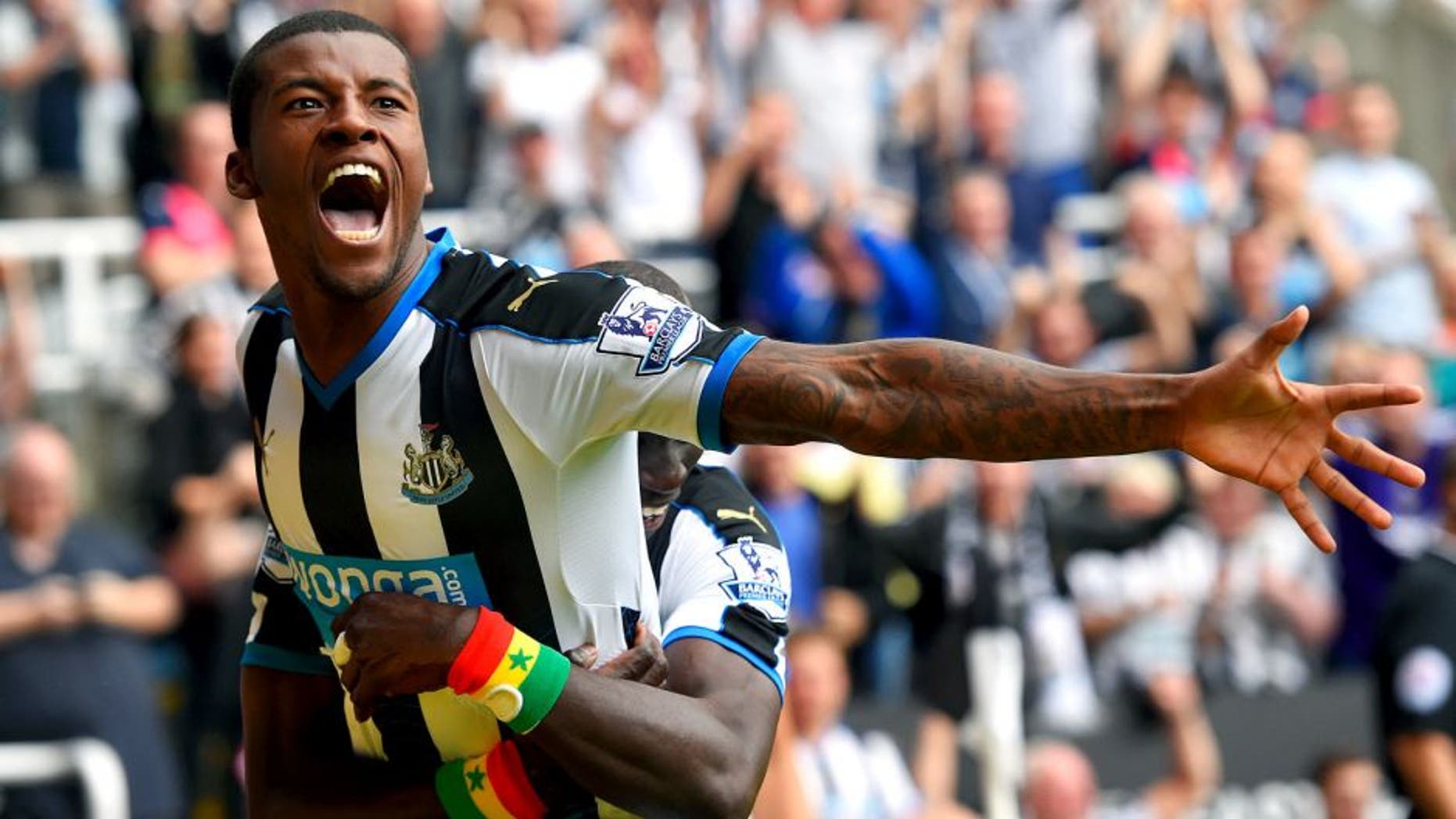 NEWCASTLE UPON TYNE, ENGLAND - AUGUST 09: Georginio Wijnaldum of Newcastle United celebrates scoring their second goal with Papiss Demba Cisse of Newcastle United during the Barclays Premier League match between Newcastle United and Southampton at St James' Park on August 9, 2015 in Newcastle upon Tyne, England. (Photo by Stu Forster/Getty Images)