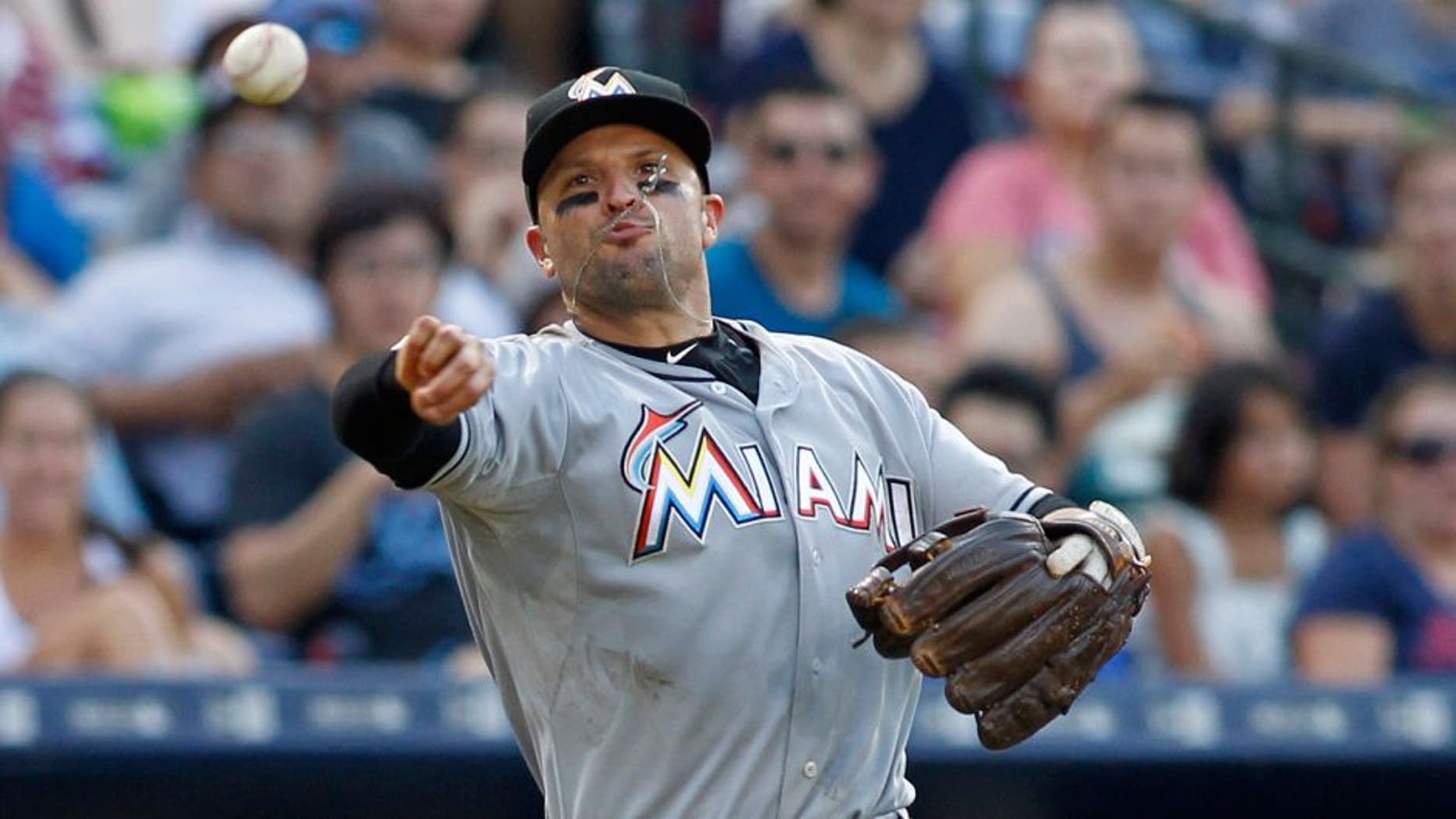 Aug 9, 2015; Atlanta, GA, USA; Miami Marlins third baseman Martin Prado (14) throws a runner out at first against the Atlanta Braves in the fifth inning at Turner Field. Mandatory Credit: Brett Davis-USA TODAY Sports