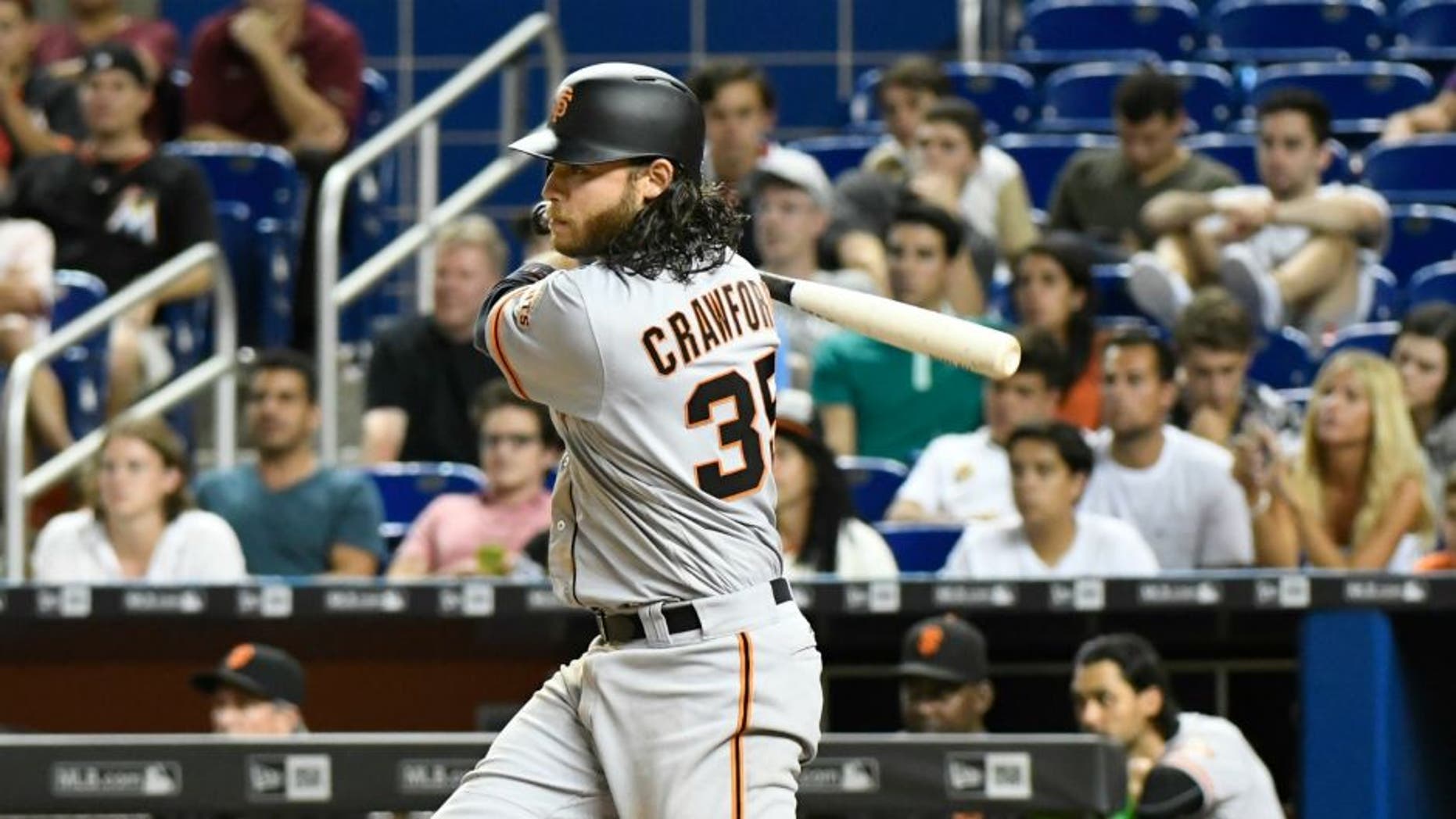 MIAMI, FL - AUGUST 08: Brandon Crawford #35 of the San Francisco Giants hit a base hit in the top of the 14th inning to score Brandon Belt #9 against the Miami Marlins at Marlins Park on August 8, 2016 in Miami, Florida. (Photo by Eric Espada/Getty Images) *** Local Caption *** Brandon Crawford