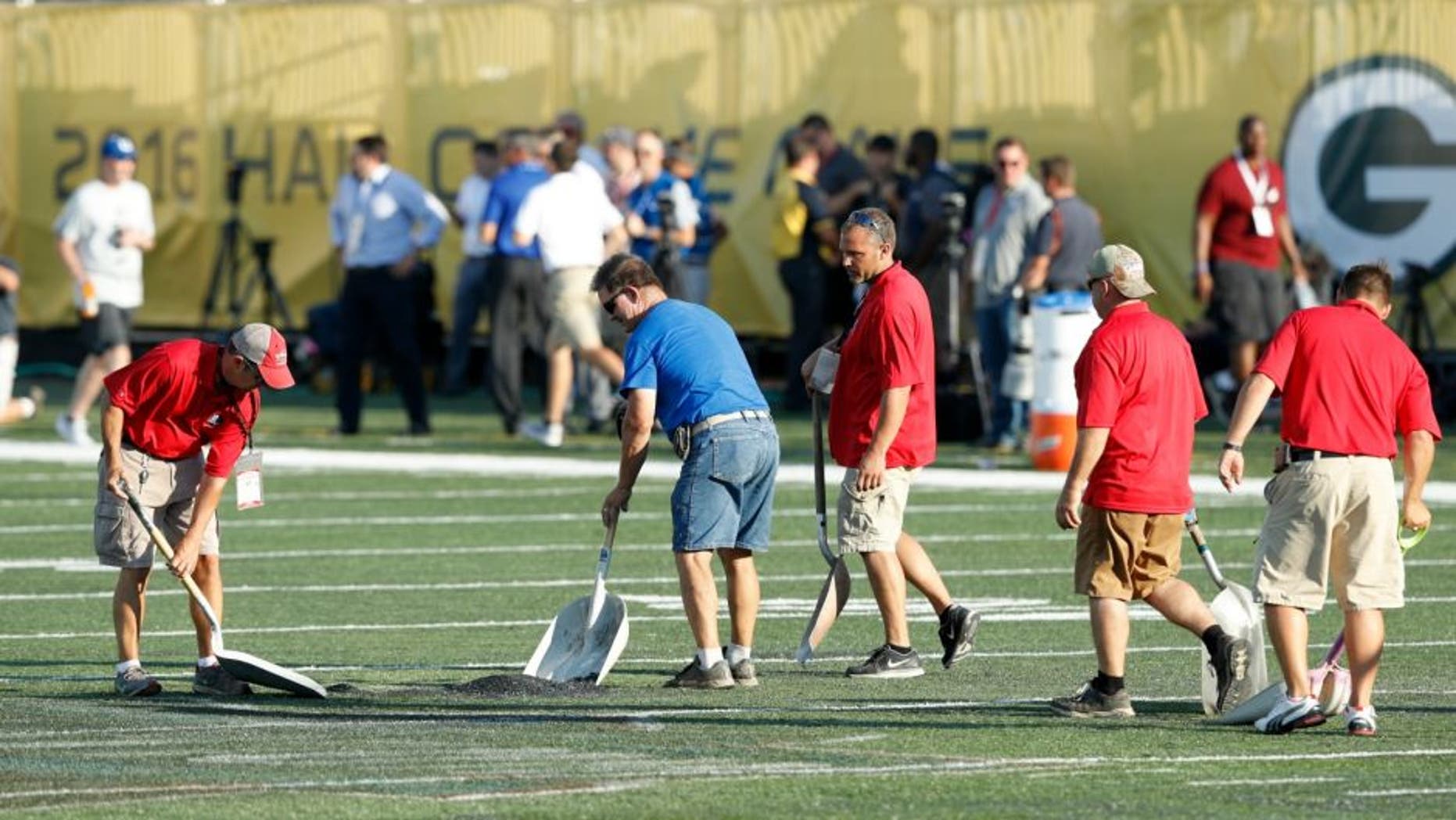 CANTON, OH - AUGUST 07: Crews work on the field prior to the NFL Hall of Fame Game between the Green Bay Packers and Indianapolis Colts at Tom Benson Hall of Fame Stadium on August 7, 2016 in Canton, Ohio. The game was cancelled due to poor field conditions. (Photo by Joe Robbins/Getty Images)