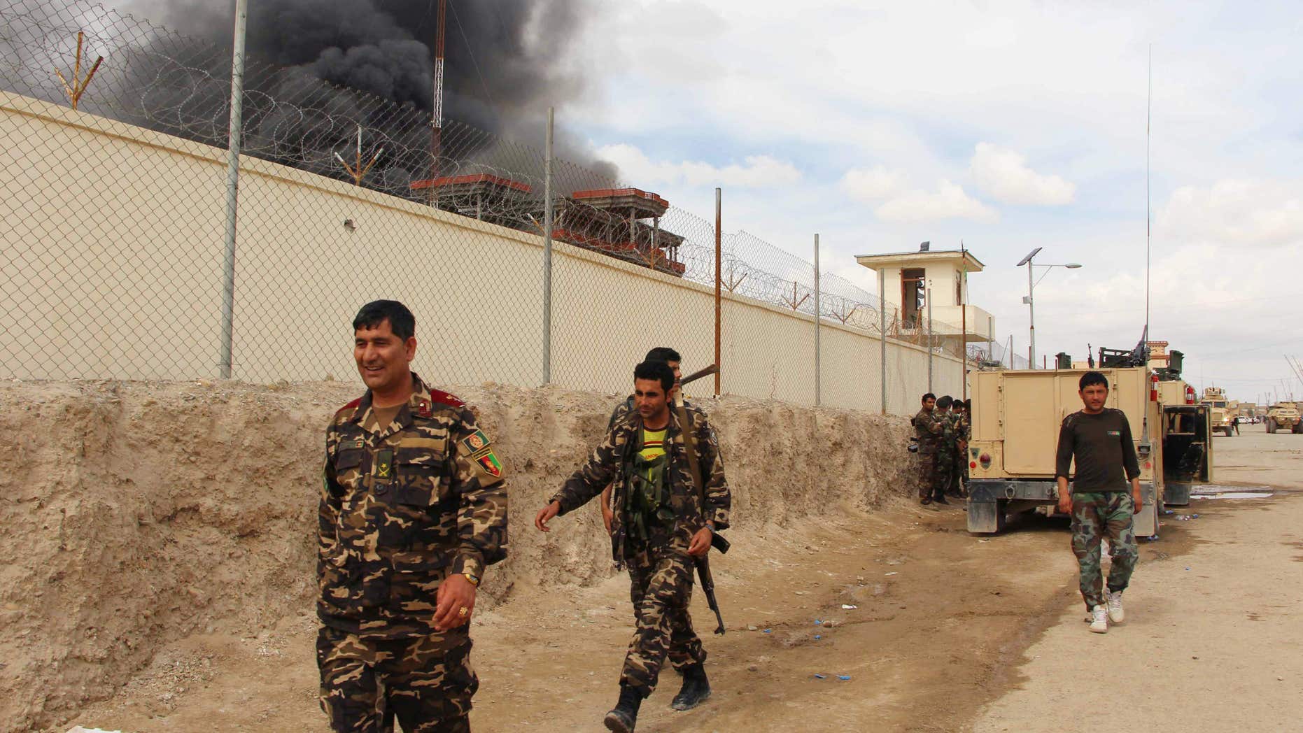 FILE -- In this March 9, 2016 file photo, smoke rises from a building, where Taliban insurgents hide during a fire fight with Afghan security forces, in Helmand province, south west Afghanistan.