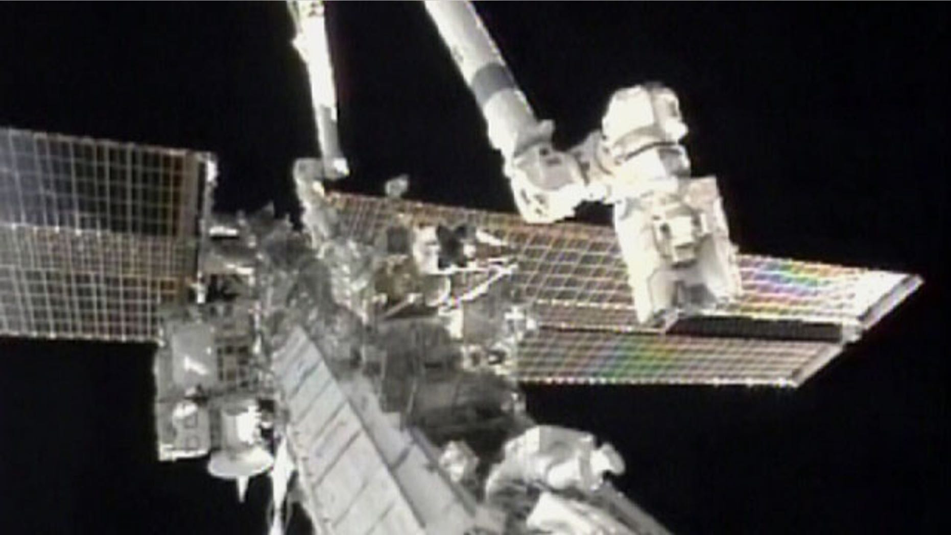 Aug. 7: In this image taken from video and made available by NASA, astronauts Douglas Wheelock, top, and Tracy Caldwell Dyson work on the International Space Station to restore a crucial cooling system.